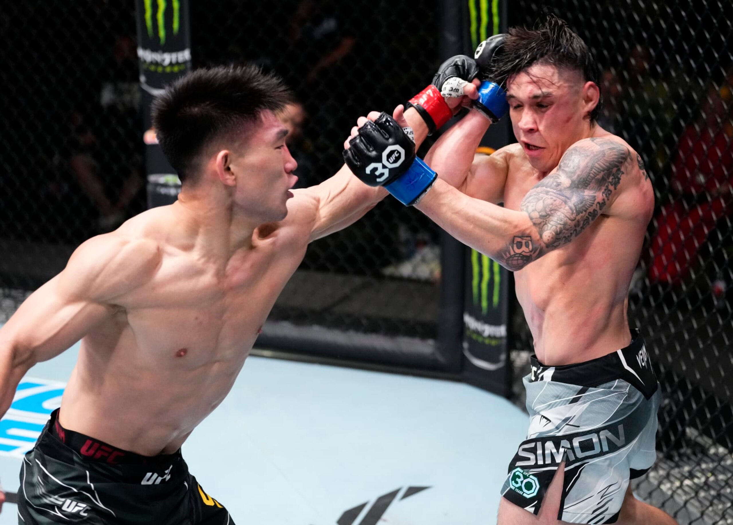LAS VEGAS, NEVADA - APRIL 29: (L-R) Song Yadong of China punches Ricky Simon in a bantamweight fight during the UFC Fight Night event at UFC APEX on April 29, 2023 in Las Vegas, Nevada. (Photo by Jeff Bottari/Zuffa LLC via Getty Images)