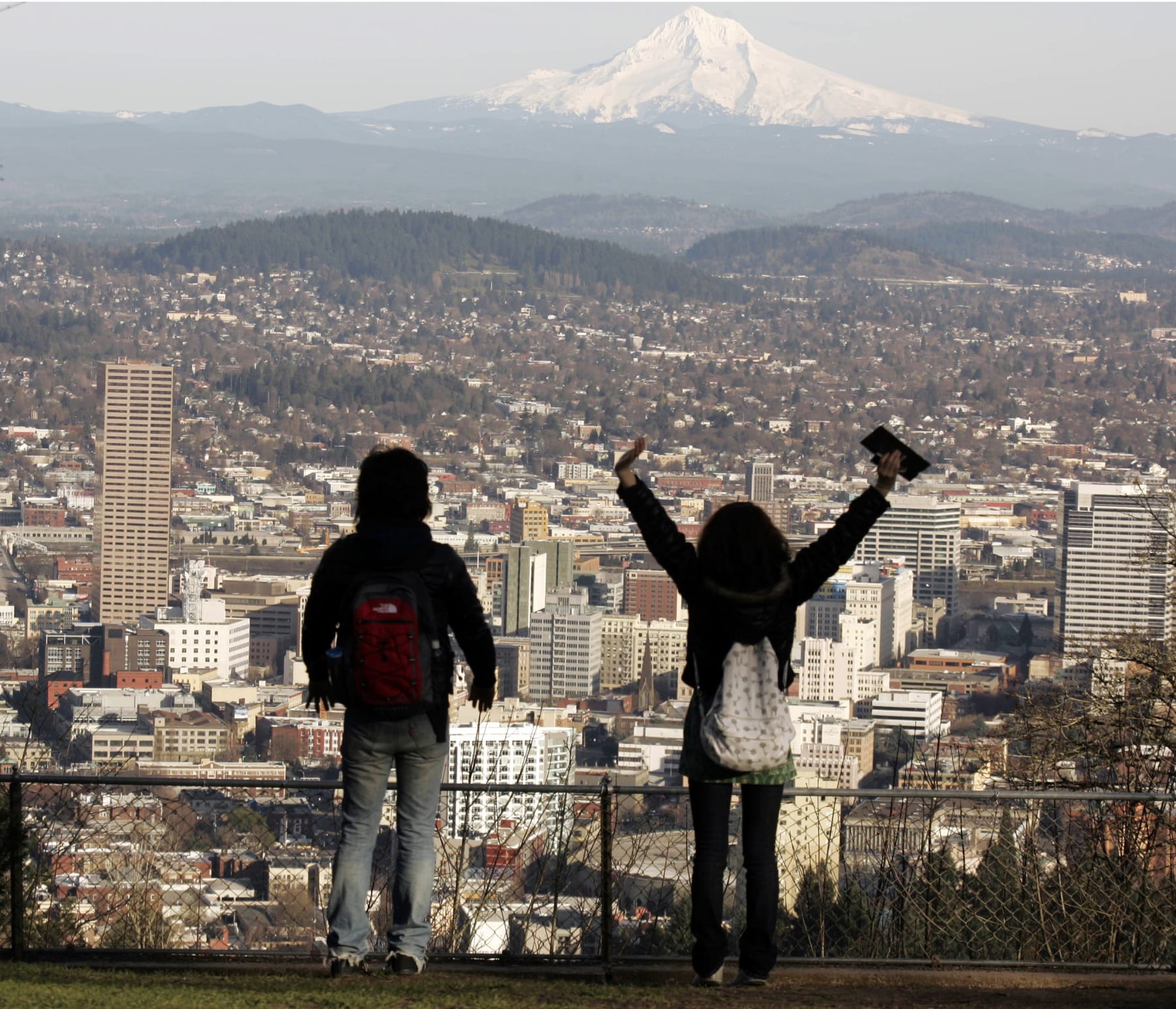 FILE - In this Feb. 26, 2008 file photo, a young couple enjoys the view of Mount Hood looming over downtown in Portland, Ore. Researchers say active fault lines on Mount Hood could potentially trigger a 7.2 magnitude quake that could reach Portland. (AP Photo/Don Ryan, File)