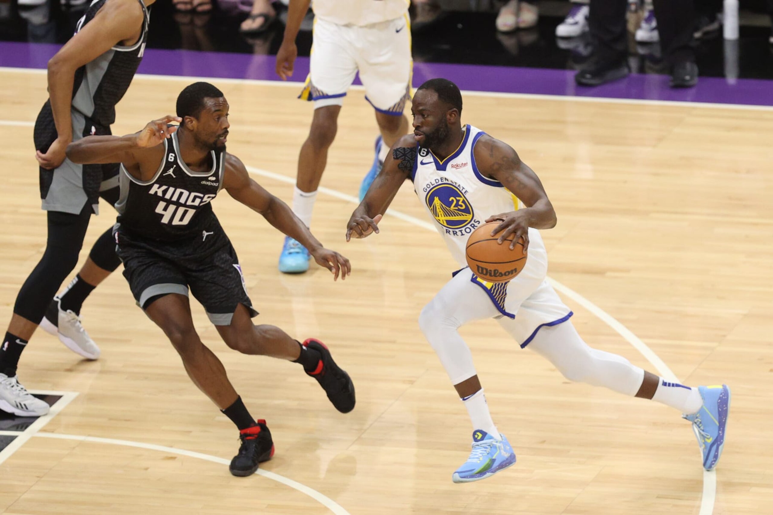 SACRAMENTO, CALIFORNIA - APRIL 30: Draymond Green #23 of the Golden State Warriors drives to the basket against Harrison Barnes #40 of the Sacramento Kings during the first quarter in game seven of the Western Conference First Round Playoffs at Golden 1 Center on April 30, 2023 in Sacramento, California. NOTE TO USER: User expressly acknowledges and agrees that, by downloading and or using this photograph, User is consenting to the terms and conditions of the Getty Images License Agreement. (Photo by Ezra Shaw/Getty Images)