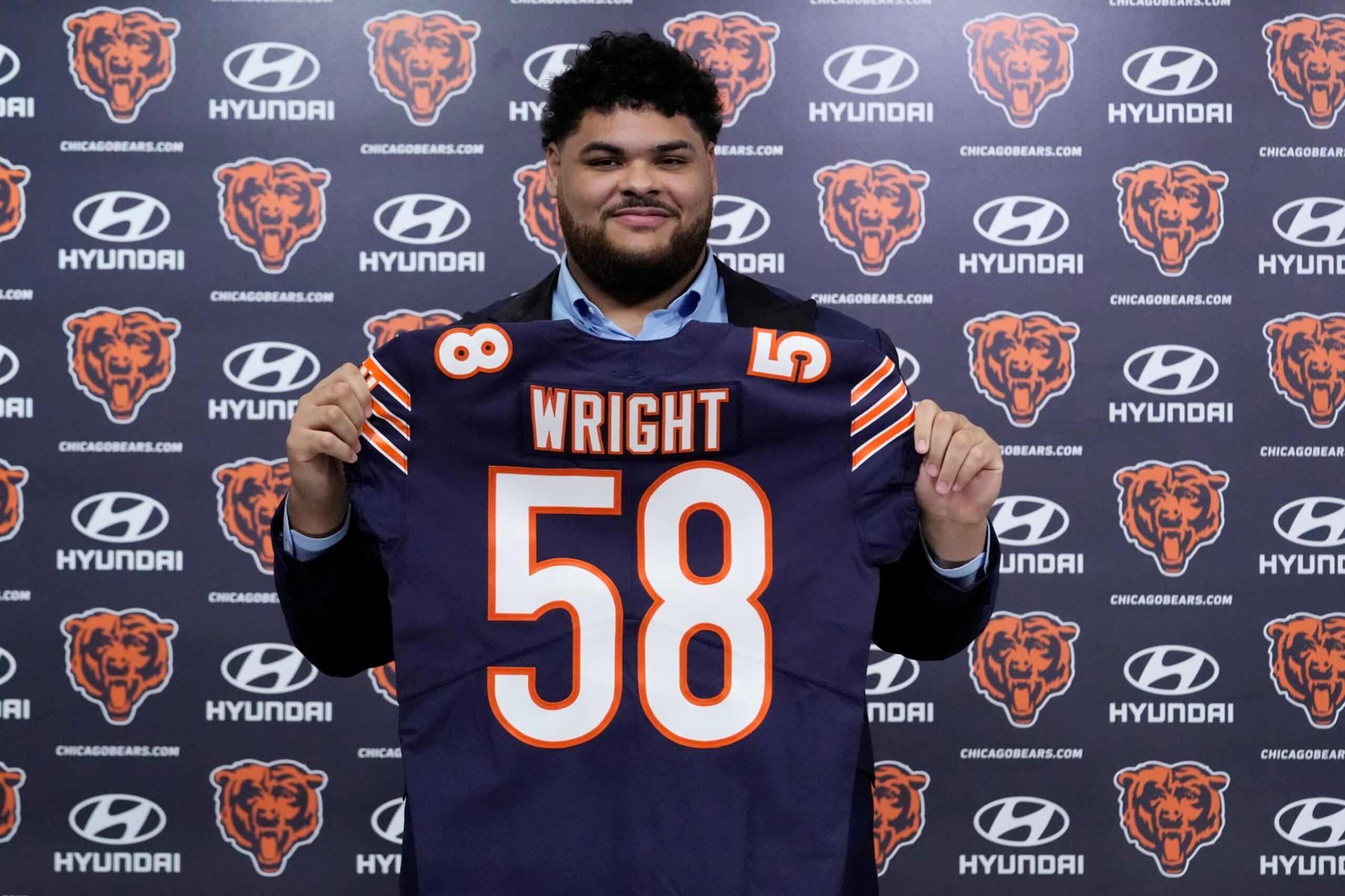 Chicago Bears number one draft pick offensive lineman Darnell Wright poses with his jersey at a news conference at Halas Hall in Lake Forest, Ill., Friday, April 28, 2023. The Chicago Bears selected offensive lineman Darnell Wright with the 10th overall pick in the first round of the 2023 NFL Draft on Thursday evening. The Bears acquired the 10th overall selection after completing a pair of trades with the Carolina Panthers on March 15, and the Philadelphia Eagles on Thursday night. (AP Photo/Nam Y. Huh)