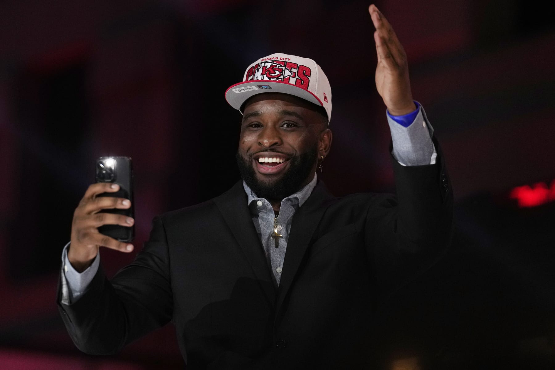 Former Kansas State defensive lineman Felix Anudike-Uzomah reacts on stage during the second round of the NFL football draft, Friday, April 28, 2023, in Kansas City, Mo. Anudike-Uzomah was picked by the Kansas City Chiefs in the first round. (AP Photo/Jeff Roberson)
