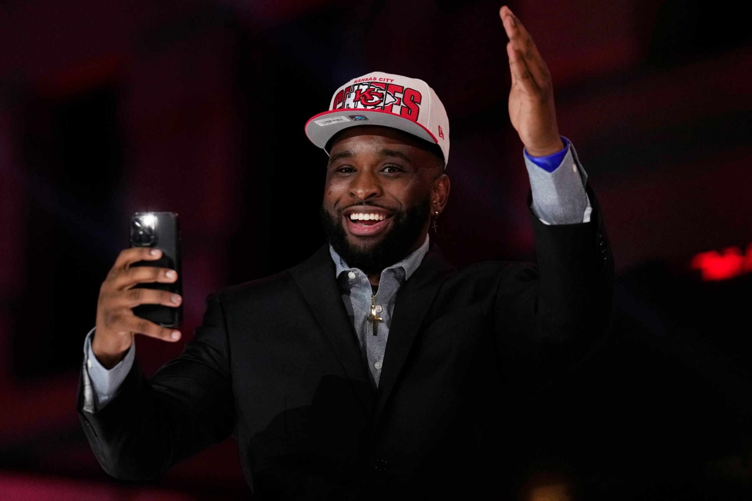Former Kansas State defensive lineman Felix Anudike-Uzomah reacts on stage during the second round of the NFL football draft, Friday, April 28, 2023, in Kansas City, Mo. Anudike-Uzomah was picked by the Kansas City Chiefs in the first round. (AP Photo/Jeff Roberson)