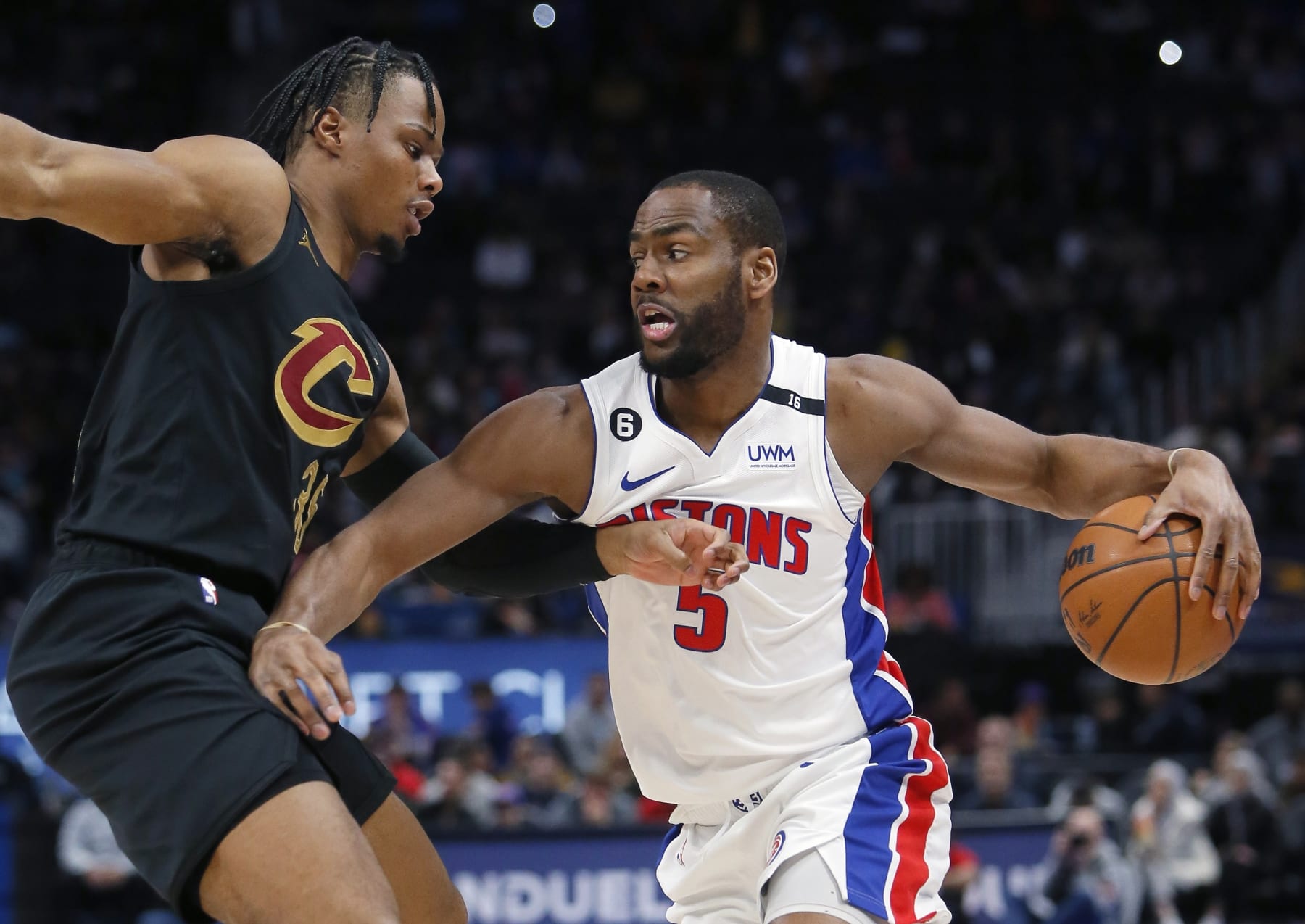 Detroit Pistons guard Alec Burks (5) drives against Cleveland Cavaliers forward Isaac Okoro during the first half of an NBA basketball game Sunday, Nov. 27, 2022, in Detroit. (AP Photo/Duane Burleson)