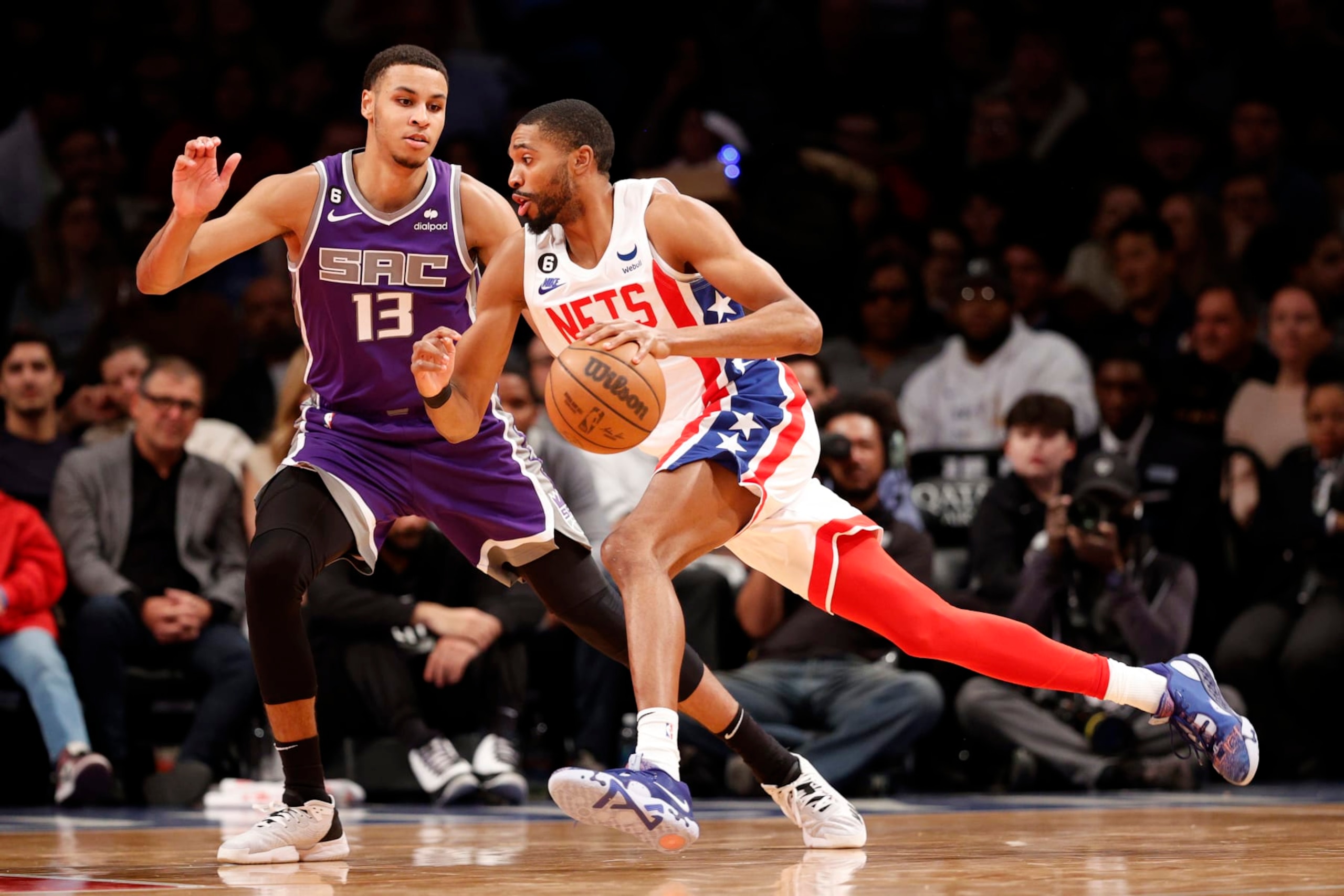 NEW YORK, NEW YORK - MARCH 16: Mikal Bridges #1 of the Brooklyn Nets dribbles as Keegan Murray #13 of the Sacramento Kings defends during the second half at Barclays Center on March 16, 2023 in New York City. The Kings won 101-96. NOTE TO USER: User expressly acknowledges and agrees that, by downloading and/or using this photograph, User is consenting to the terms and conditions of the Getty Images License Agreement. (Photo by Sarah Stier/Getty Images)