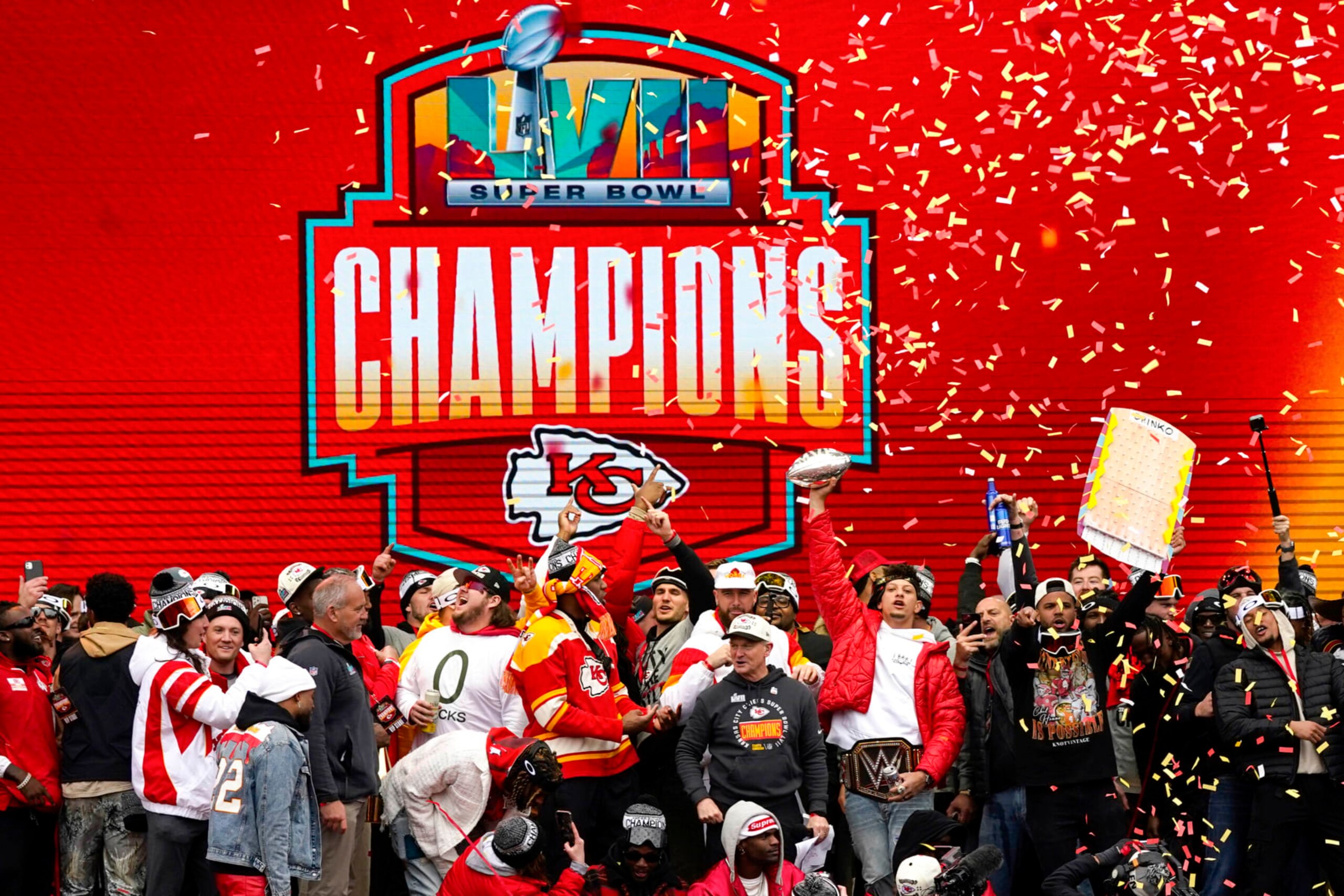 KANSAS CITY, MISSOURI - FEBRUARY 15: Patrick Mahomes #15 of the Kansas City Chiefs holds up the MVP trophy while celebrating with teammates during the Kansas City Chiefs Super Bowl LVII victory parade on February 15, 2023 in Kansas City, Missouri. (Photo by Jay Biggerstaff/Getty Images)