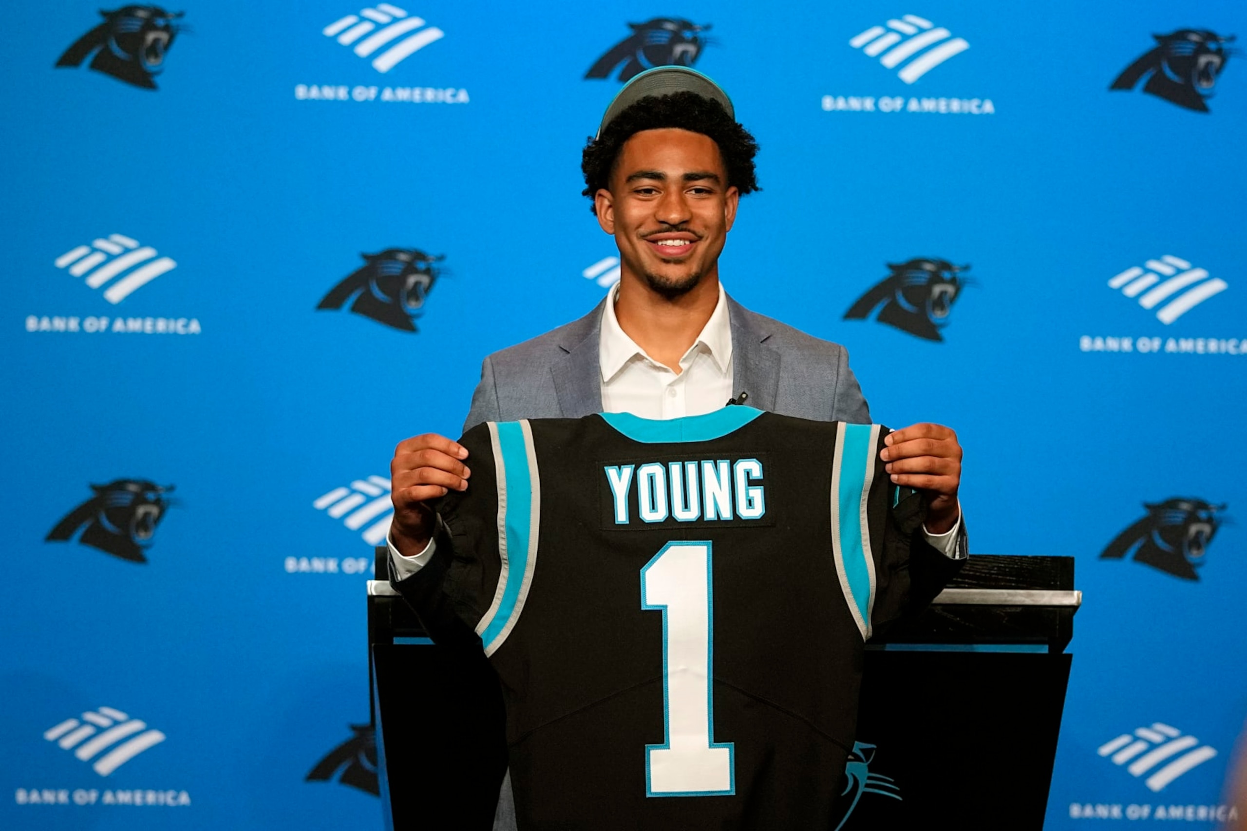 Carolina Panthers number one draft pick quarterback Bryce Young poses with his jersey during a news conference at their NFL football stadium on Friday, April 28, 2023, in Charlotte, N.C. (AP Photo/Chris Carlson)