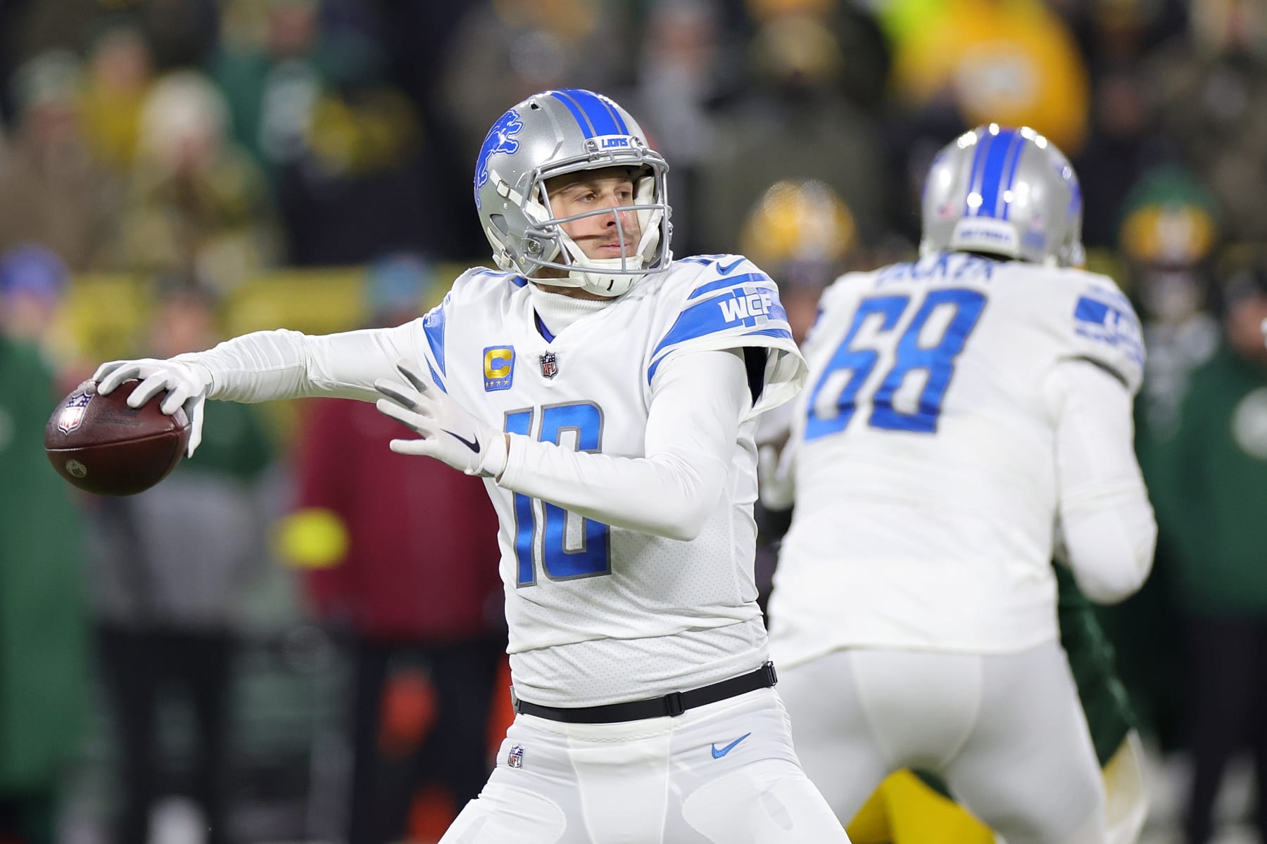 GREEN BAY, WISCONSIN - JANUARY 08: Jared Goff #16 of the Detroit Lions drops back to pass during a game against the Green Bay Packers at Lambeau Field on January 08, 2023 in Green Bay, Wisconsin. The Lions defeated the Packers 20-16. (Photo by Stacy Revere/Getty Images)