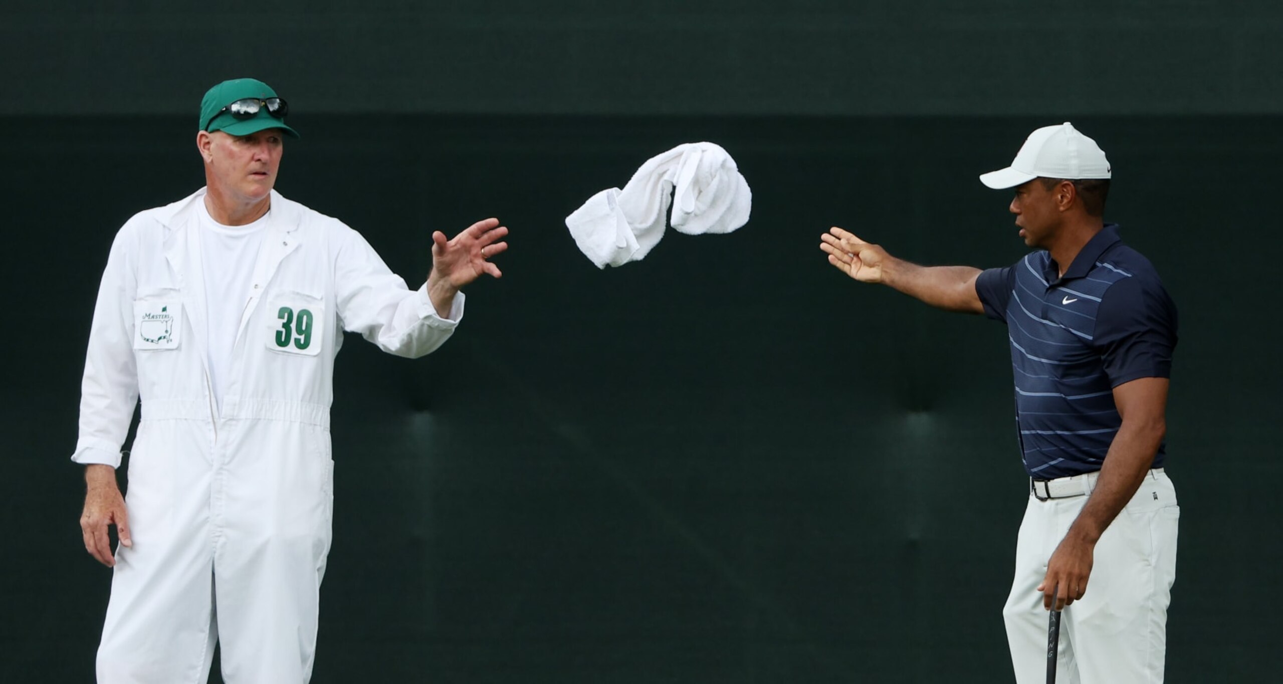 AUGUSTA, GEORGIA - APRIL 07: Tiger Woods of the United States throws a towel to caddie Joe LaCava on the fifth hole during the second round of the 2023 Masters Tournament at Augusta National Golf Club on April 07, 2023 in Augusta, Georgia. (Photo by Patrick Smith/Getty Images)