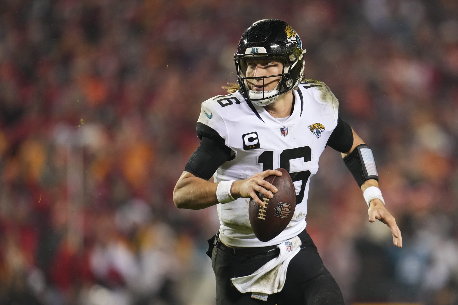 KANSAS CITY, MO - JANUARY 21: Trevor Lawrence #16 of the Jacksonville Jaguars scrambles against the Kansas City Chiefs at GEHA Field at Arrowhead Stadium on January 21, 2023 in Kansas City, Missouri. (Photo by Cooper Neill/Getty Images)