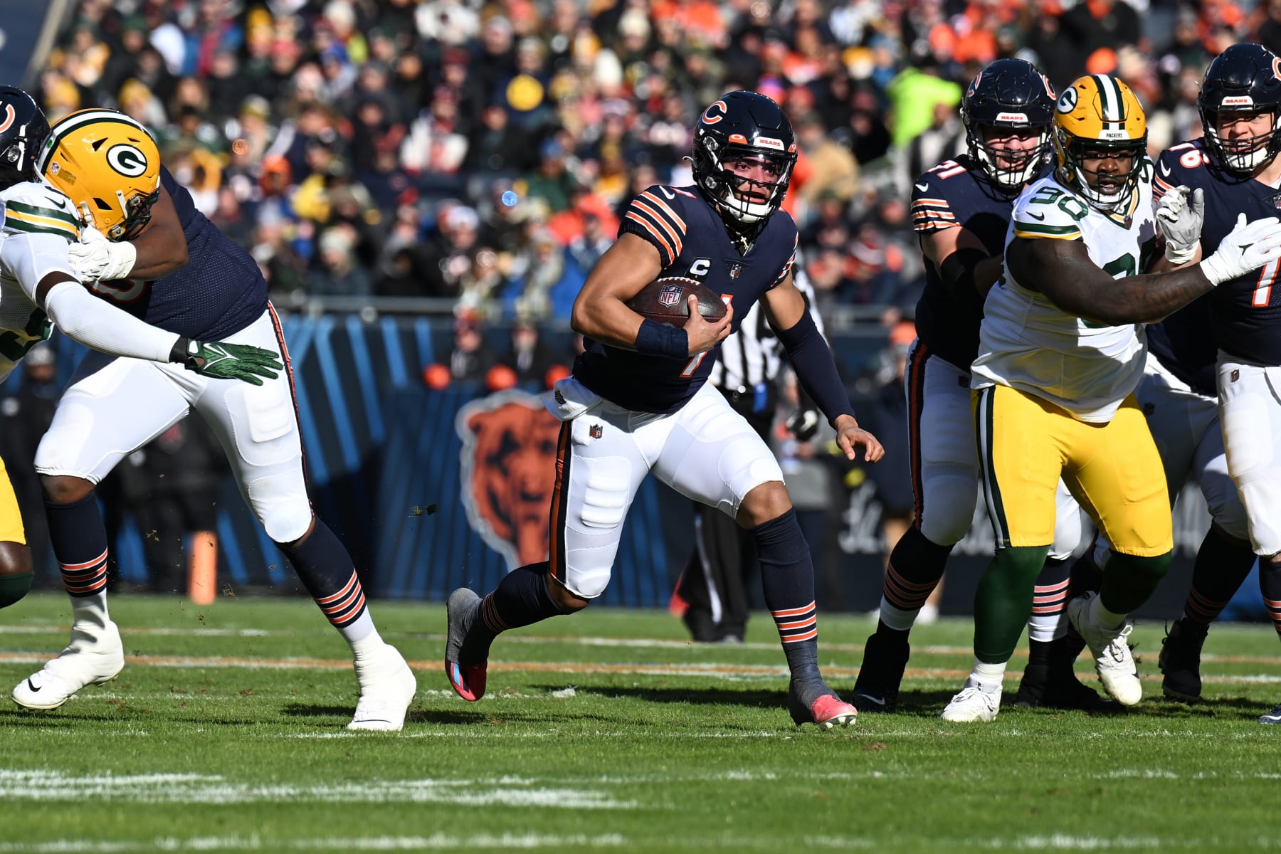 CHICAGO, ILLINOIS - DECEMBER 04: Justin Fields #1 of the Chicago Bears rushes for a first down against the Green Bay Packers during the first half of the game at Soldier Field on December 04, 2022 in Chicago, Illinois. (Photo by Quinn Harris/Getty Images)