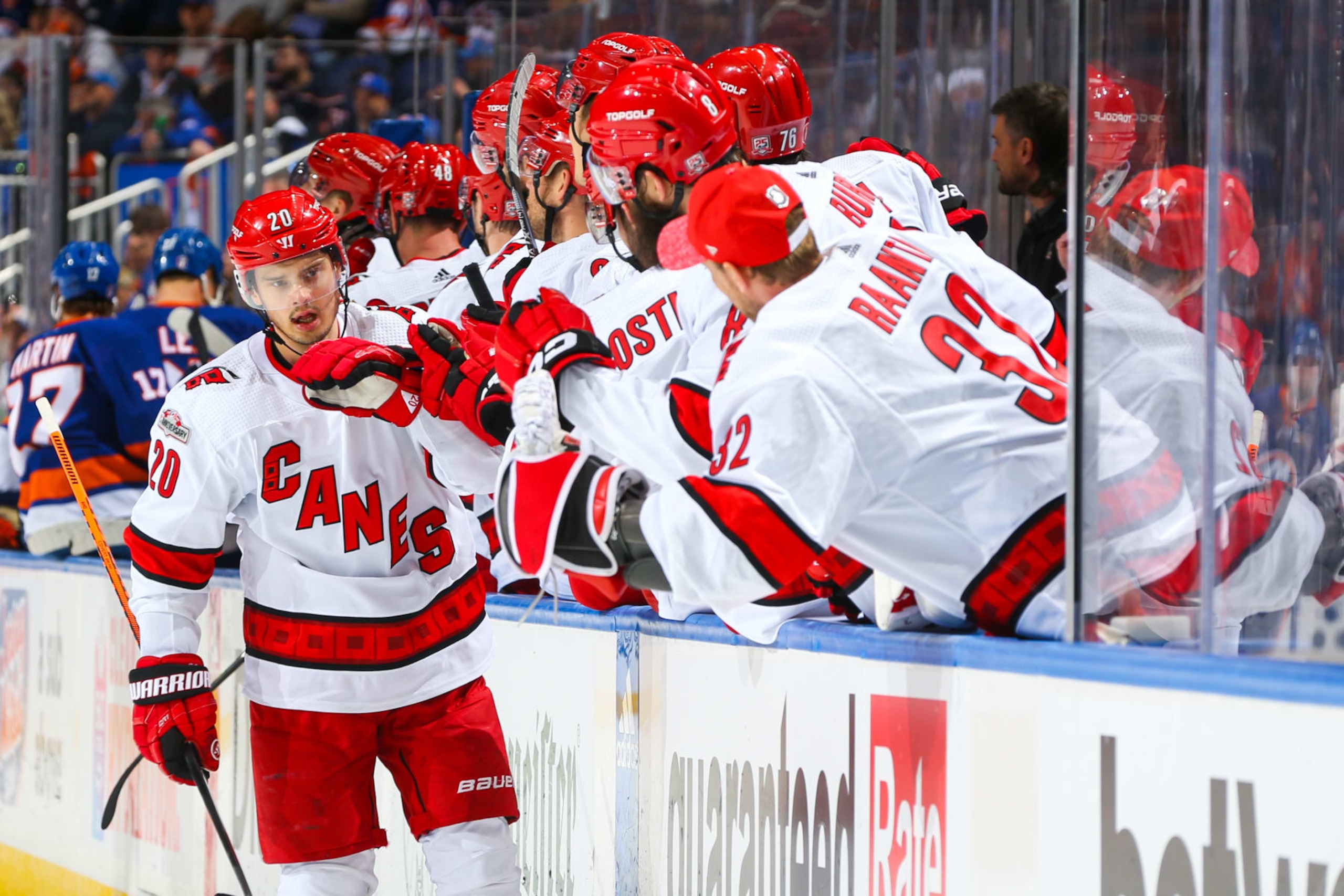 ELMONT, NEW YORK - APRIL 28:  Sebastian Aho #20 of the Carolina Hurricanes celebrates with teammates after scoring a goal in the third period against the New York Islanders in Game Six of the First Round of the 2023 Stanley Cup Playoffs at UBS Arena on April 28, 2023 in Elmont, New York. (Photo by Mike Stobe/NHLI via Getty Images)