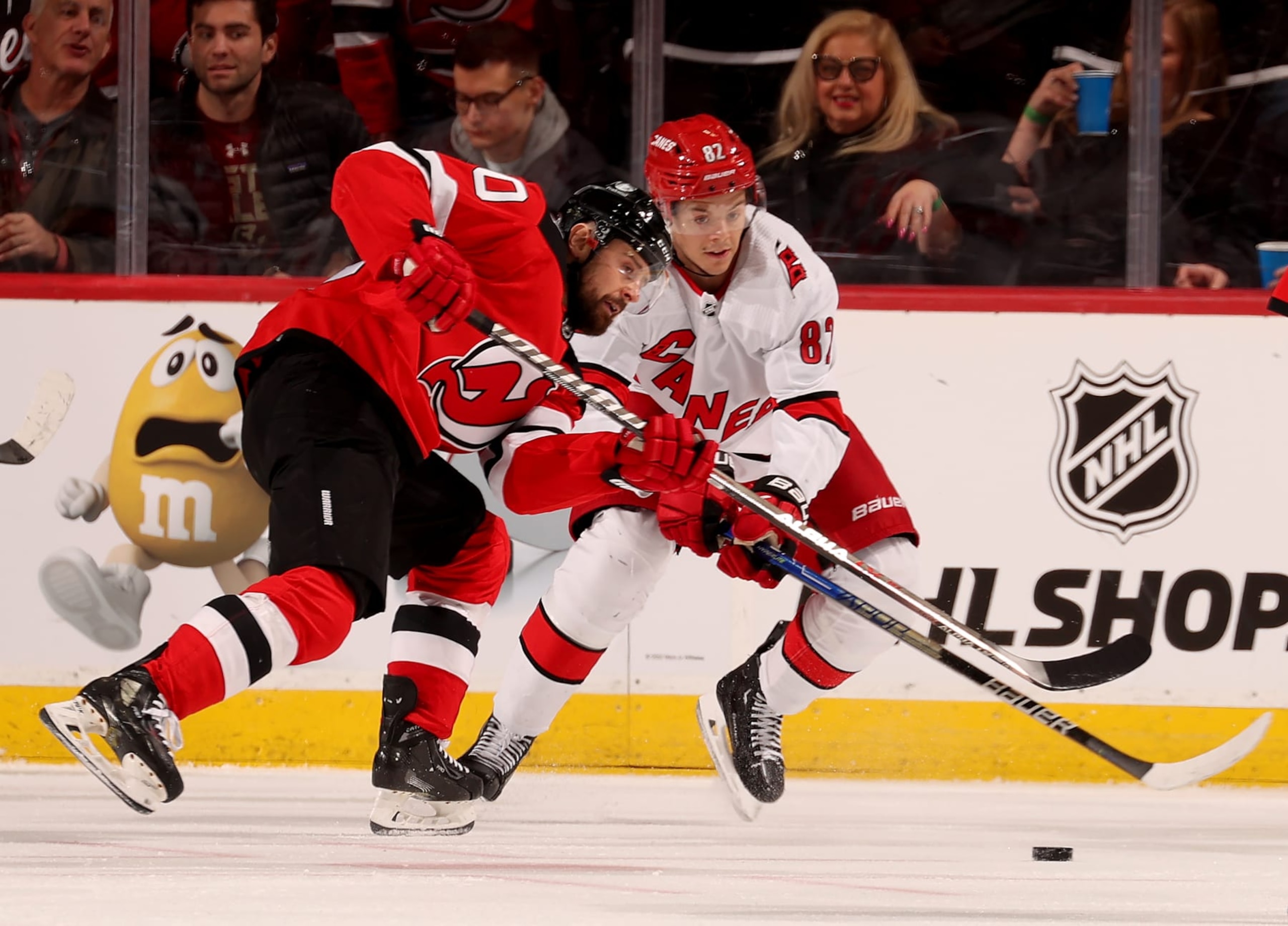 NEWARK, NEW JERSEY - MARCH 12: Tomas Tatar #90 of the New Jersey Devils and Jesperi Kotkaniemi #82 of the Carolina Hurricanes fight for the puck during the second period at Prudential Center on March 12, 2023 in Newark, New Jersey. (Photo by Elsa/Getty Images)