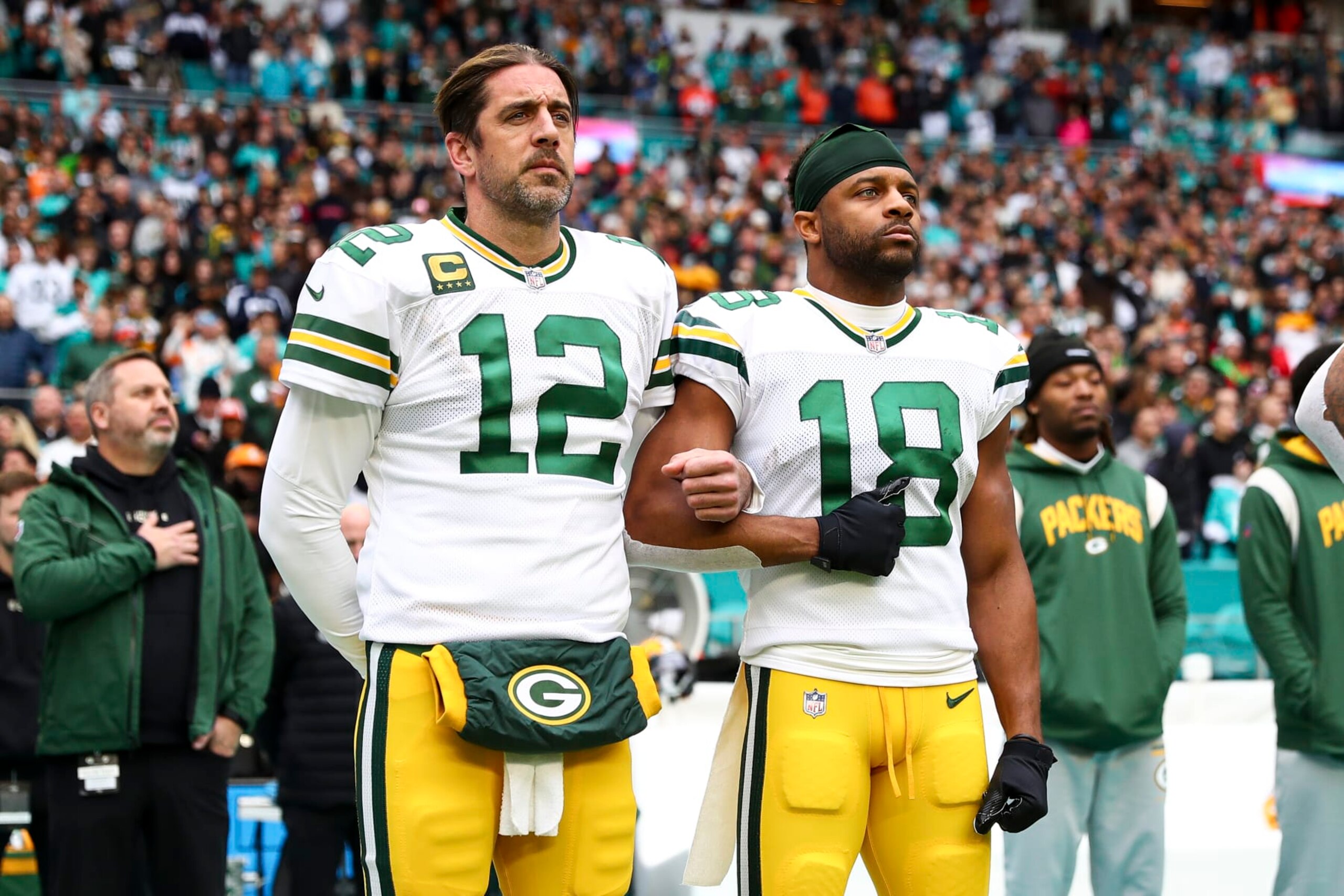 MIAMI GARDENS, FL - DECEMBER 25: Aaron Rodgers #12 of the Green Bay Packers links arms with Randall Cobb #18 on the sidelines during the national anthem before an NFL football game against the Miami Dolphins at Hard Rock Stadium on December 25, 2022 in Miami Gardens, Florida. (Photo by Kevin Sabitus/Getty Images) MIAMI GARDENS, FL - DECEMBER 25: Aaron Rodgers #12 of the Green Bay Packers links arms with Randall Cobb #18 on the sidelines during the national anthem before an NFL football game against the Miami Dolphins at Hard Rock Stadium on December 25, 2022 in Miami Gardens, Florida. (Photo by Kevin Sabitus/Getty Images)