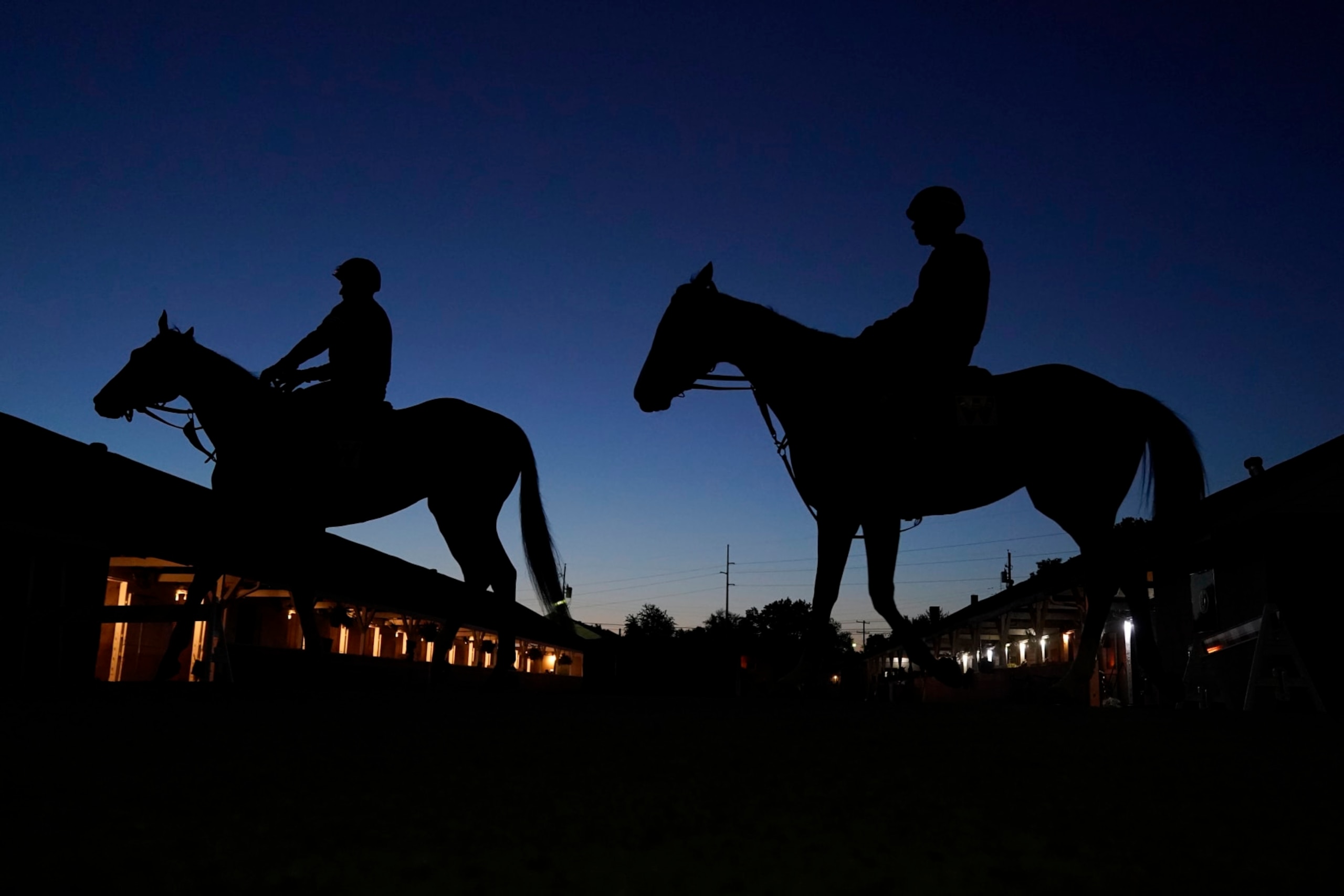 Horses head for the track for an early-morning workout at Churchill Downs Tuesday, May 2, 2023, in Louisville, Ky. The 149th running of the Kentucky Derby is scheduled for Saturday, May 6. (AP Photo/Charlie Riedel)