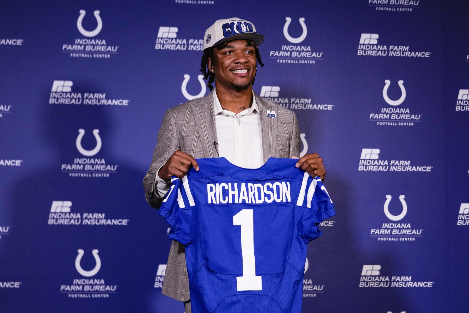 Indianapolis Colts first-round draft pick Anthony Richardson hold a Colts jersey following a news conference at the NFL football team's practice facility in Indianapolis, Friday, April 28, 2023. (AP Photo/Michael Conroy)