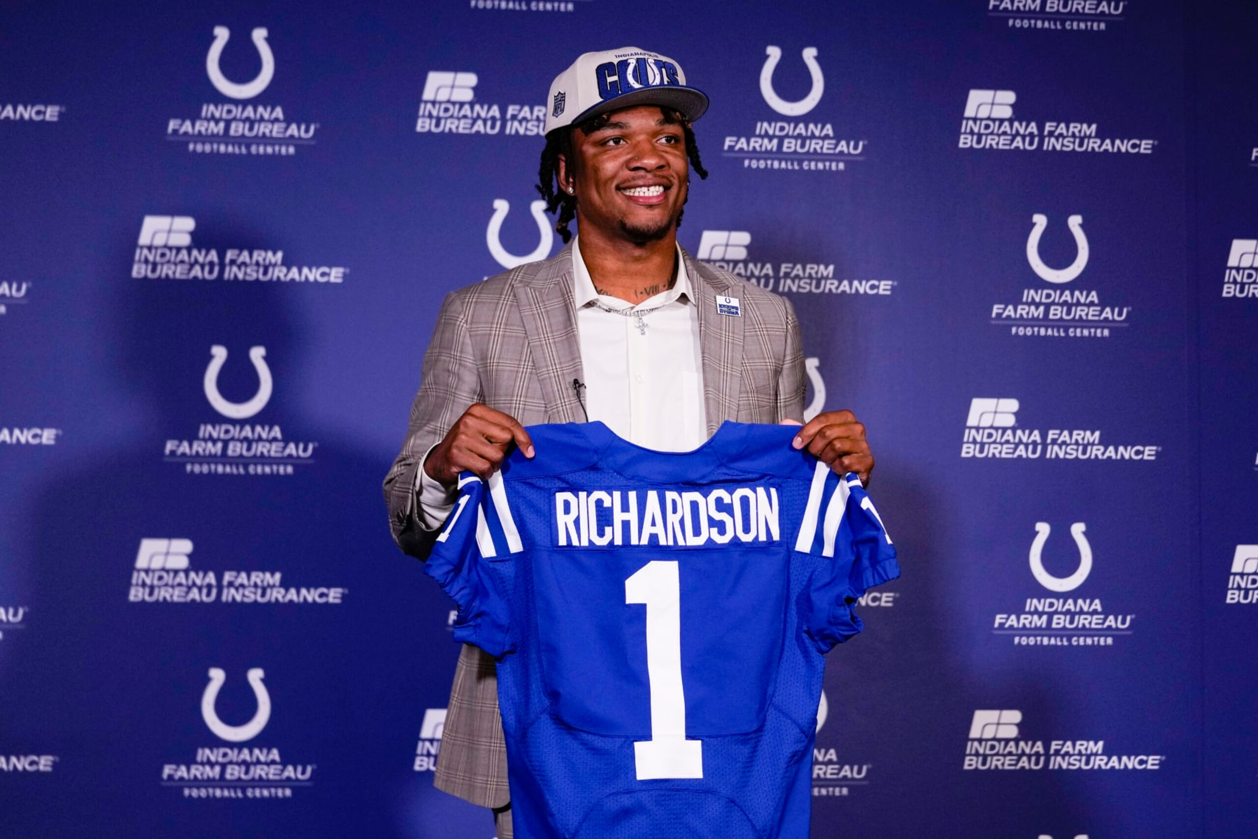 Indianapolis Colts first-round draft pick Anthony Richardson hold a Colts jersey following a news conference at the NFL football team's practice facility in Indianapolis, Friday, April 28, 2023. (AP Photo/Michael Conroy)