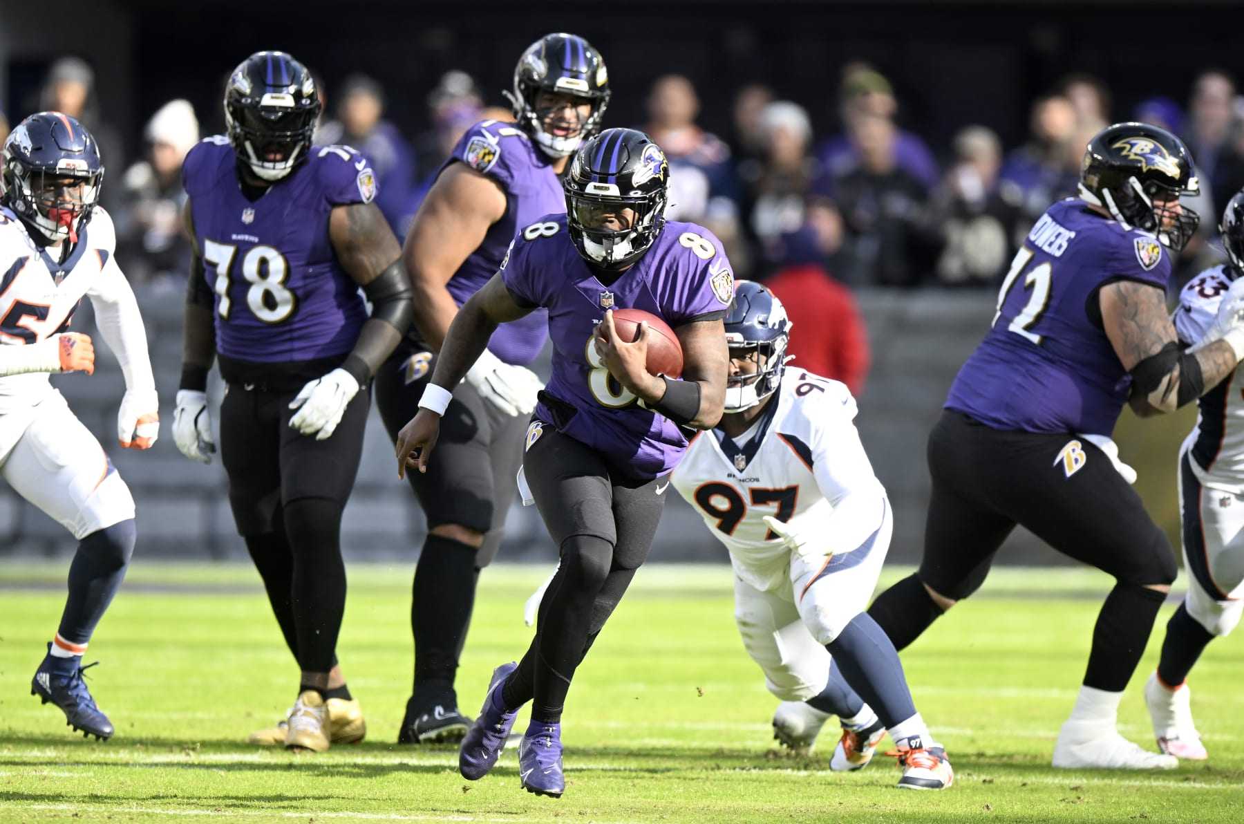 BALTIMORE, MARYLAND - DECEMBER 04: Lamar Jackson #8 of the Baltimore Ravens runs the ball against the Denver Broncos at M&T Bank Stadium on December 04, 2022 in Baltimore, Maryland. (Photo by G Fiume/Getty Images)