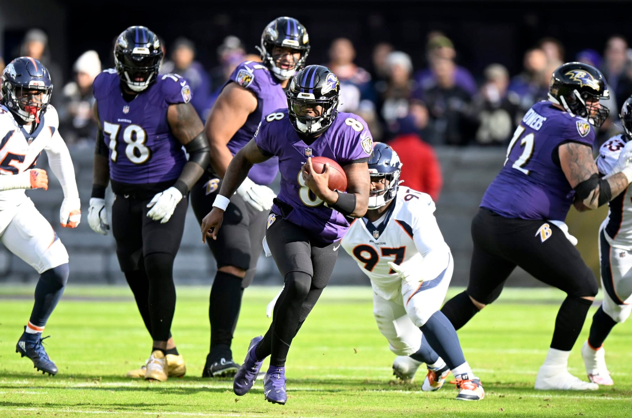 BALTIMORE, MARYLAND - DECEMBER 04: Lamar Jackson #8 of the Baltimore Ravens runs the ball against the Denver Broncos at M&T Bank Stadium on December 04, 2022 in Baltimore, Maryland. (Photo by G Fiume/Getty Images)