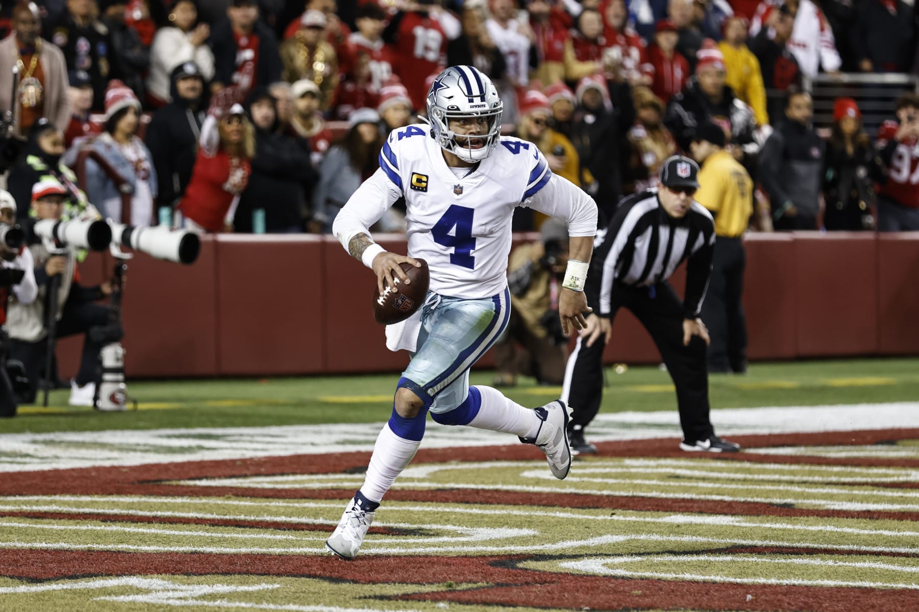 SANTA CLARA, CALIFORNIA - JANUARY 22: Dak Prescott #4 of the Dallas Cowboys scrambles and runs with the ball during an NFL divisional round playoff football game between the San Francisco 49ers and the Dallas Cowboys at Levi's Stadium on January 22, 2023 in Santa Clara, California. (Photo by Michael Owens/Getty Images)