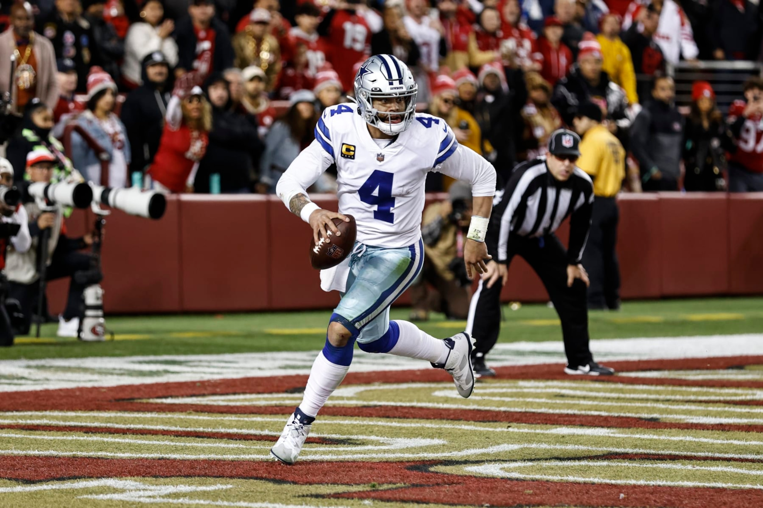 SANTA CLARA, CALIFORNIA - JANUARY 22: Dak Prescott #4 of the Dallas Cowboys scrambles and runs with the ball during an NFL divisional round playoff football game between the San Francisco 49ers and the Dallas Cowboys at Levi's Stadium on January 22, 2023 in Santa Clara, California. (Photo by Michael Owens/Getty Images) SANTA CLARA, CALIFORNIA - JANUARY 22: Dak Prescott #4 of the Dallas Cowboys scrambles and runs with the ball during an NFL divisional round playoff football game between the San Francisco 49ers and the Dallas Cowboys at Levi's Stadium on January 22, 2023 in Santa Clara, California. (Photo by Michael Owens/Getty Images)