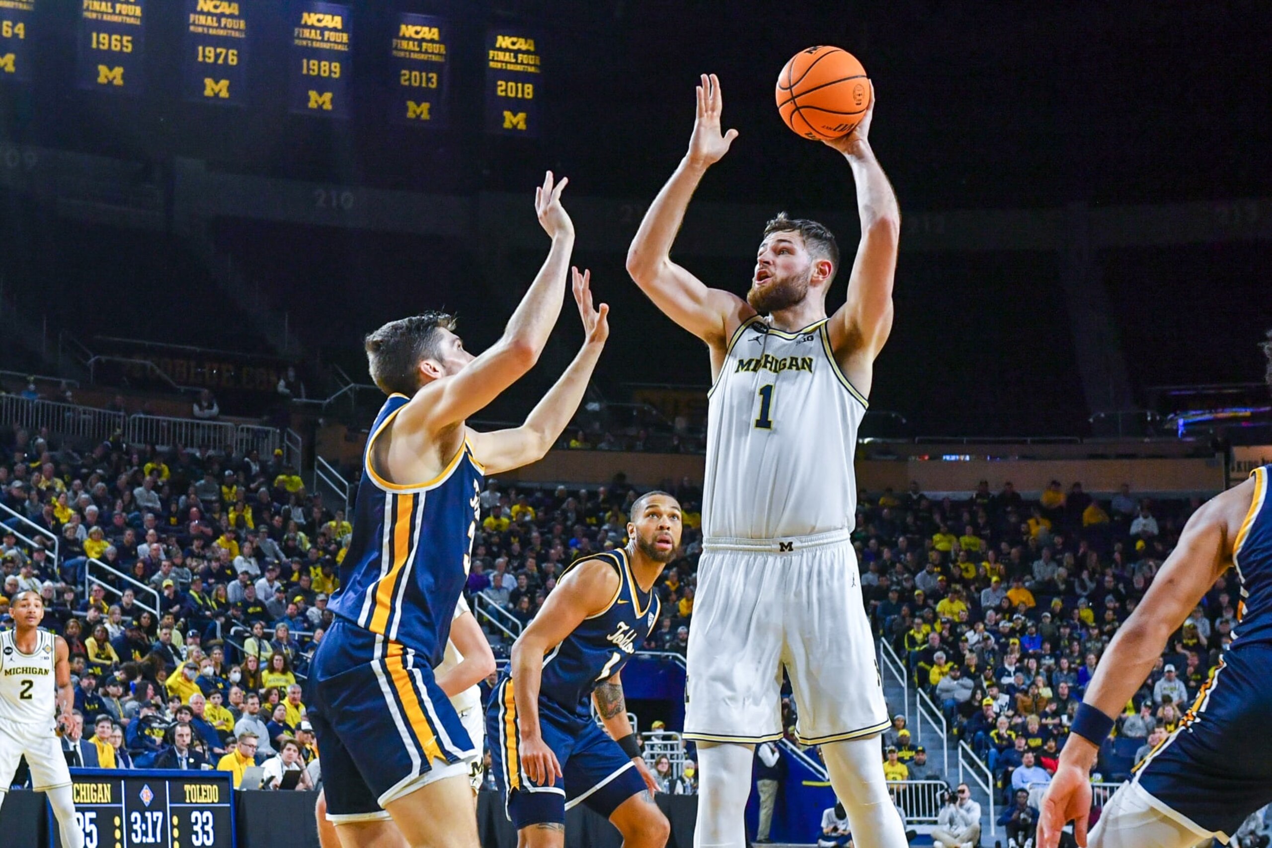 ANN ARBOR, MICHIGAN - MARCH 14: Hunter Dickinson #1 of the Michigan Wolverines attempts a shot over J.T. Shumate #32 of the Toledo Rockets during the first half an NIT college basketball first round game at Crisler Arena on March 14, 2023 in Ann Arbor, Michigan. (Photo by Aaron J. Thornton/Getty Images)