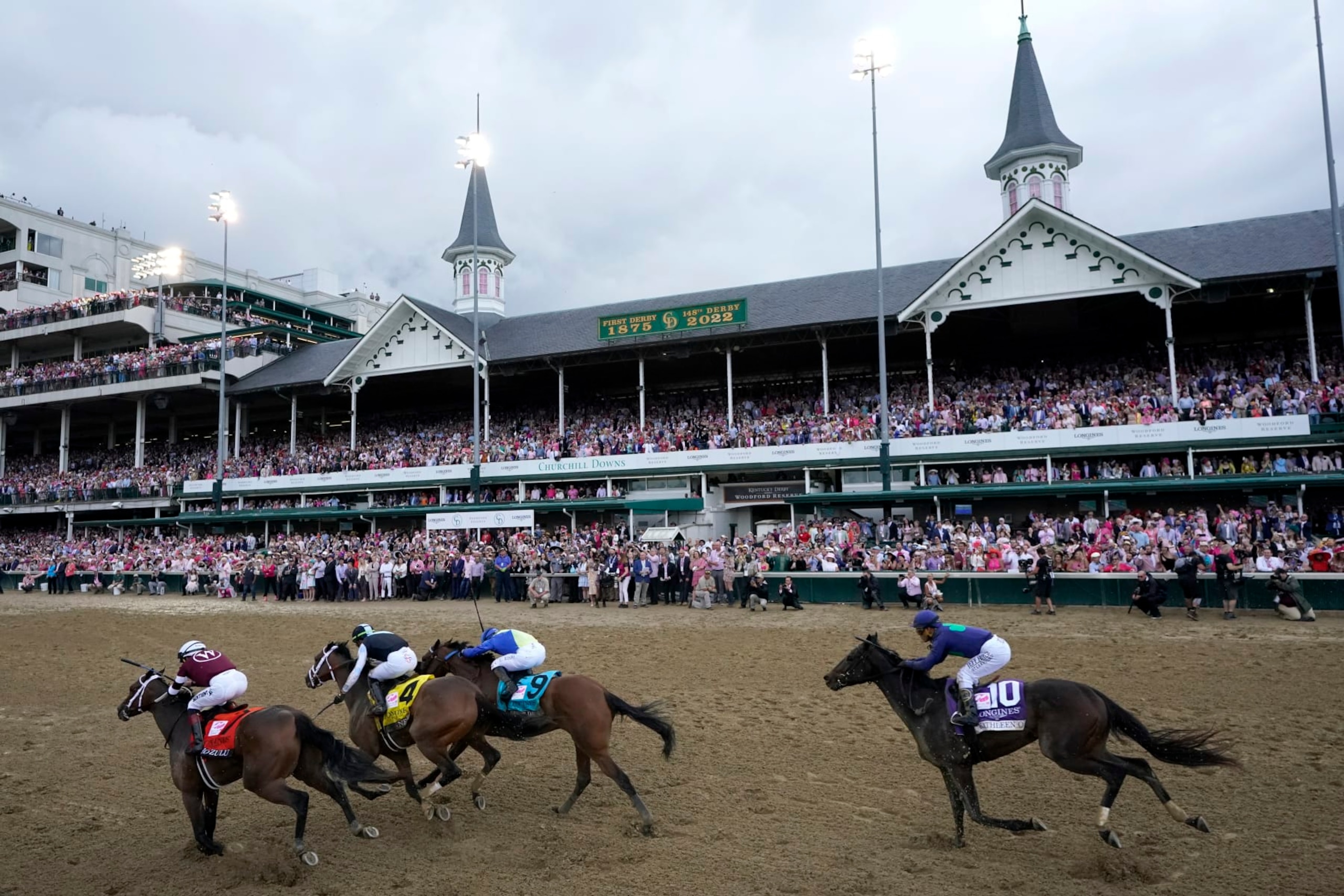 FILE- Horses run during the 148th running of the Kentucky Oaks horse race at Churchill Downs on May 6, 2022, in Louisville, Ky. Churchill Downs has modified paths to the Kentucky Derby and Oaks, awarding points to the top five finishers in qualifying races and increasing significance for the Breeders’ Cup Juvenile and late prep season events. (AP Photo/Jeff Roberson, File)