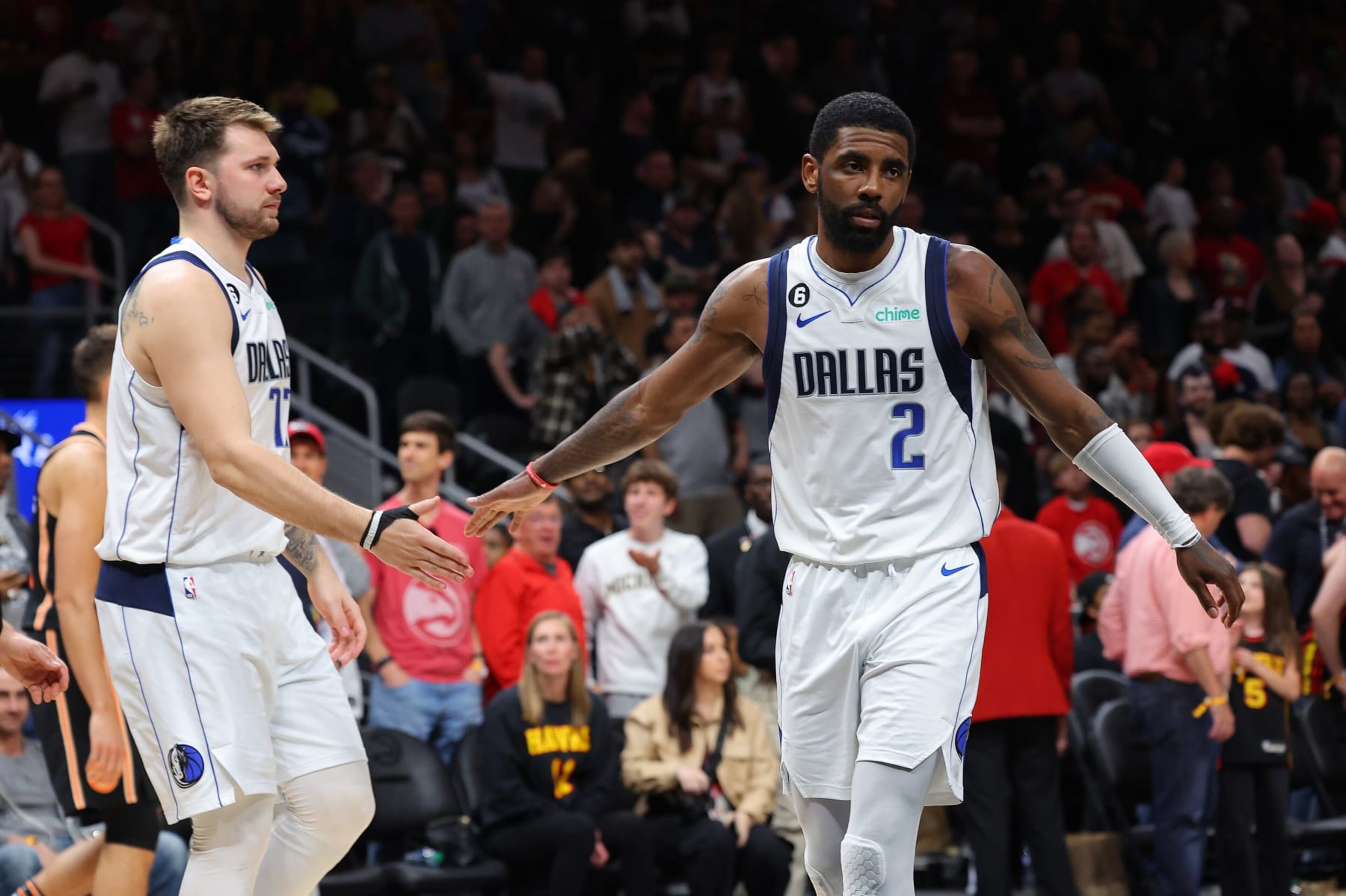 ATLANTA, GEORGIA - APRIL 02:  Luka Doncic #77 and Kyrie Irving #2 of the Dallas Mavericks react against the Atlanta Hawks during the fourth quarter at State Farm Arena on April 02, 2023 in Atlanta, Georgia.  NOTE TO USER: User expressly acknowledges and agrees that, by downloading and or using this photograph, User is consenting to the terms and conditions of the Getty Images License Agreement.  (Photo by Kevin C. Cox/Getty Images)