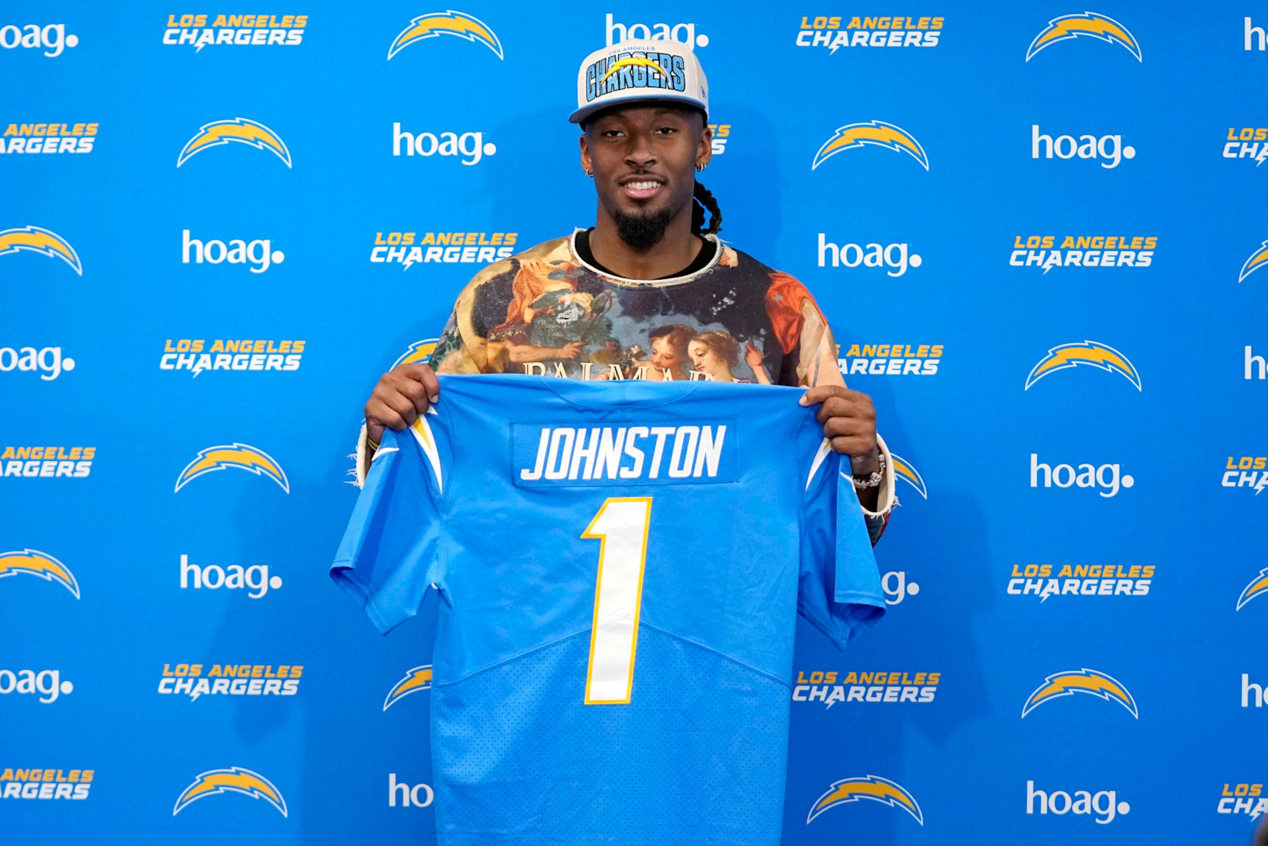Quentin Johnston poses with his jersey after speaking at a news conference Friday, April 28, 2023, in Costa Mesa, Calif. to introduce him after he was drafted Thursday by the Los Angeles Chargers. The TCU wide receiver was the 21st pick in the NFL draft. (AP Photo/Mark J. Terrill) Quentin Johnston poses with his jersey after speaking at a news conference Friday, April 28, 2023, in Costa Mesa, Calif. to introduce him after he was drafted Thursday by the Los Angeles Chargers. The TCU wide receiver was the 21st pick in the NFL draft. (AP Photo/Mark J. Terrill)