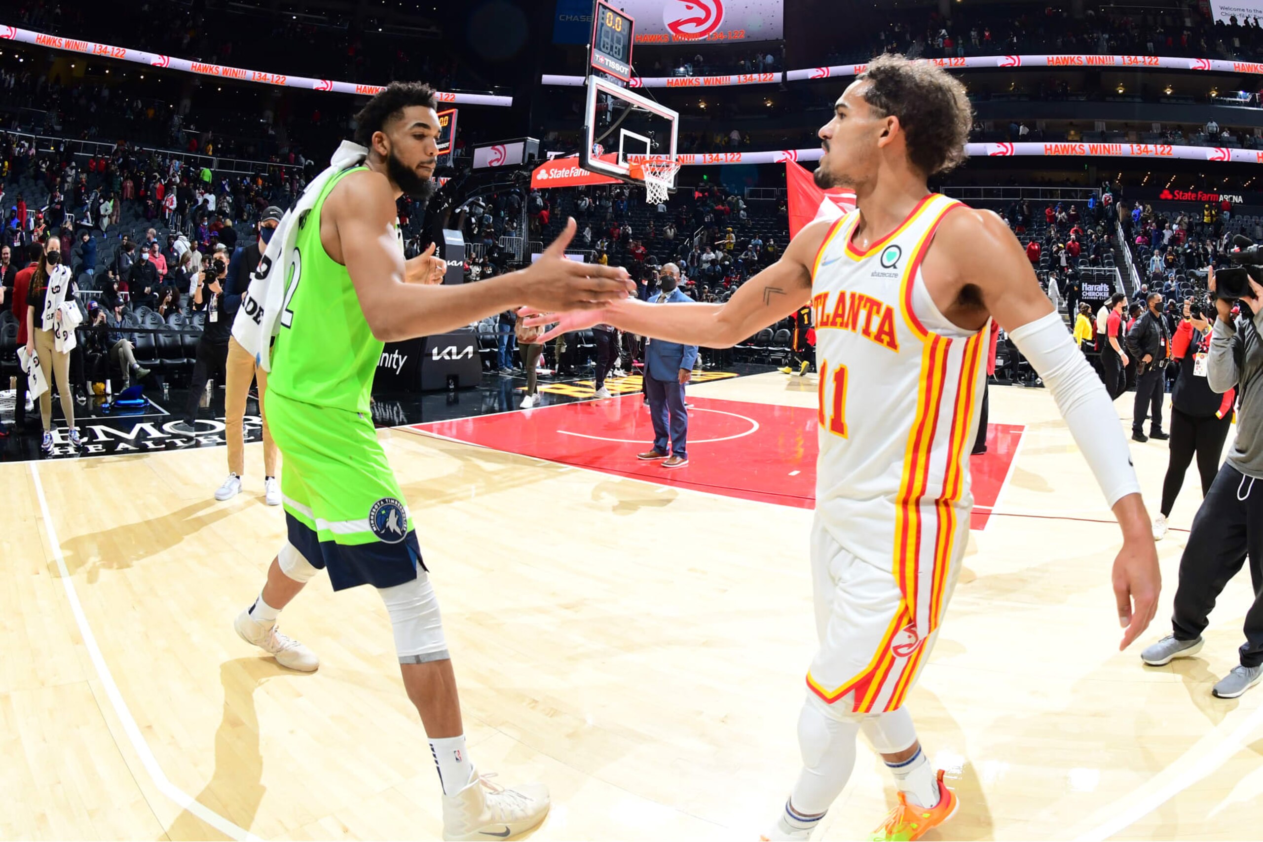 ATLANTA, GA - JANUARY 19: Trae Young #11 of the Atlanta Hawks high fives Karl-Anthony Towns #32 of the Minnesota Timberwolves after the game on January 19, 2022 at State Farm Arena in Atlanta, Georgia.  NOTE TO USER: User expressly acknowledges and agrees that, by downloading and/or using this Photograph, user is consenting to the terms and conditions of the Getty Images License Agreement. Mandatory Copyright Notice: Copyright 2022 NBAE (Photo by Scott Cunningham/NBAE via Getty Images)