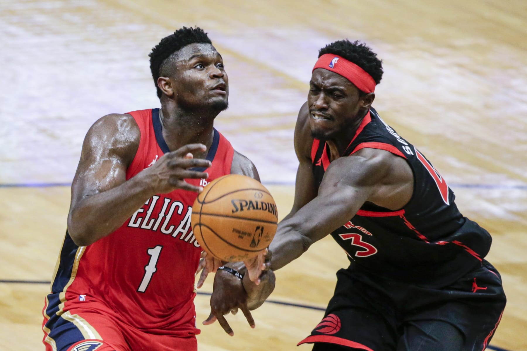 New Orleans Pelicans forward Zion Williamson (1) is fouled as he drives to the basket by Toronto Raptor forward Pascal Siakam (43) during the second half of an NBA basketball game on Saturday, Jan. 2, 2021, in New Orleans. (AP Photo/Butch Dill)