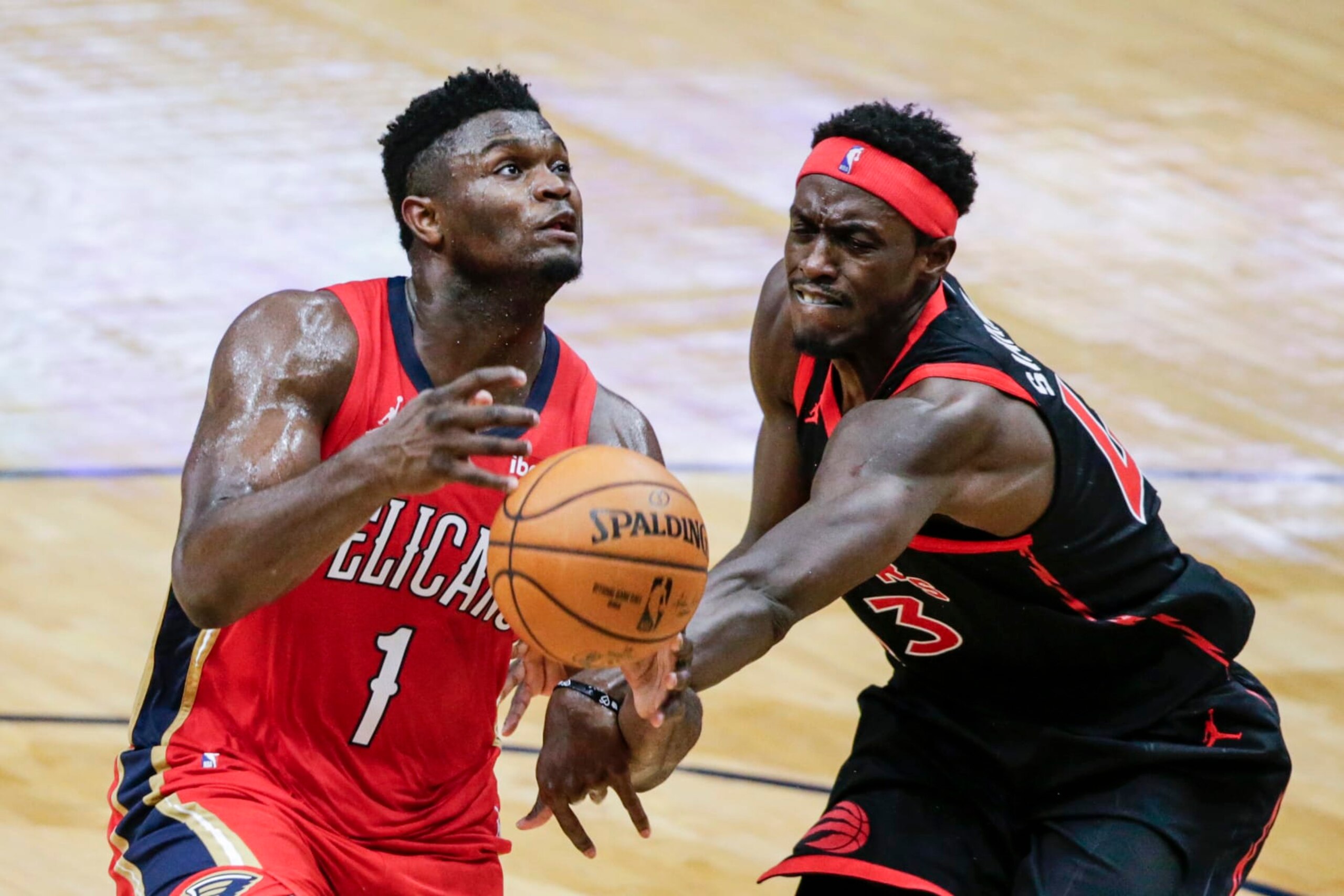 New Orleans Pelicans forward Zion Williamson (1) is fouled as he drives to the basket by Toronto Raptor forward Pascal Siakam (43) during the second half of an NBA basketball game on Saturday, Jan. 2, 2021, in New Orleans. (AP Photo/Butch Dill)