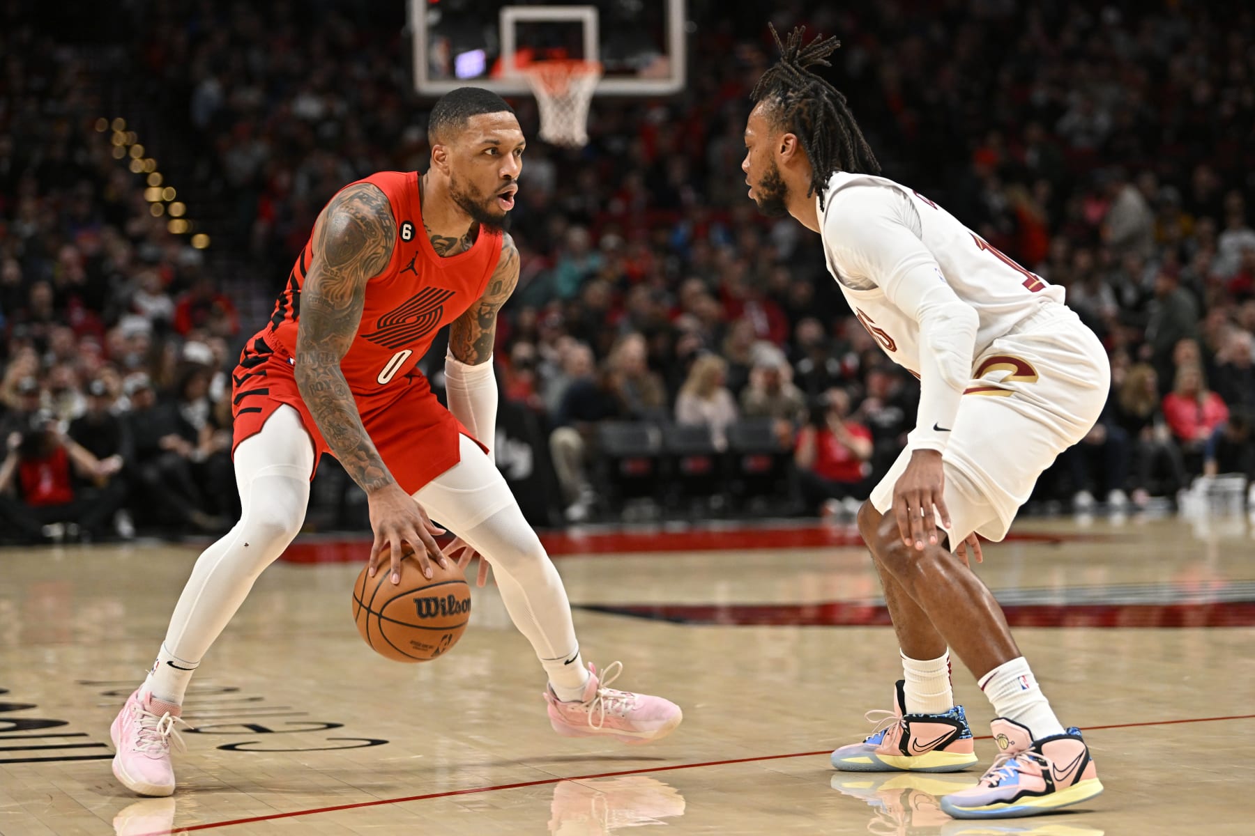 PORTLAND, OREGON - JANUARY 12: Damian Lillard #0 of the Portland Trail Blazers controls the ball against Darius Garland #10 of the Cleveland Cavaliers during the first quarter at the Moda Center on January 12, 2023 in Portland, Oregon. The Cleveland Cavaliers won 119-113. NOTE TO USER: User expressly acknowledges and agrees that, by downloading and or using this photograph, User is consenting to the terms and conditions of the Getty Images License Agreement. (Photo by Alika Jenner/Getty Images)