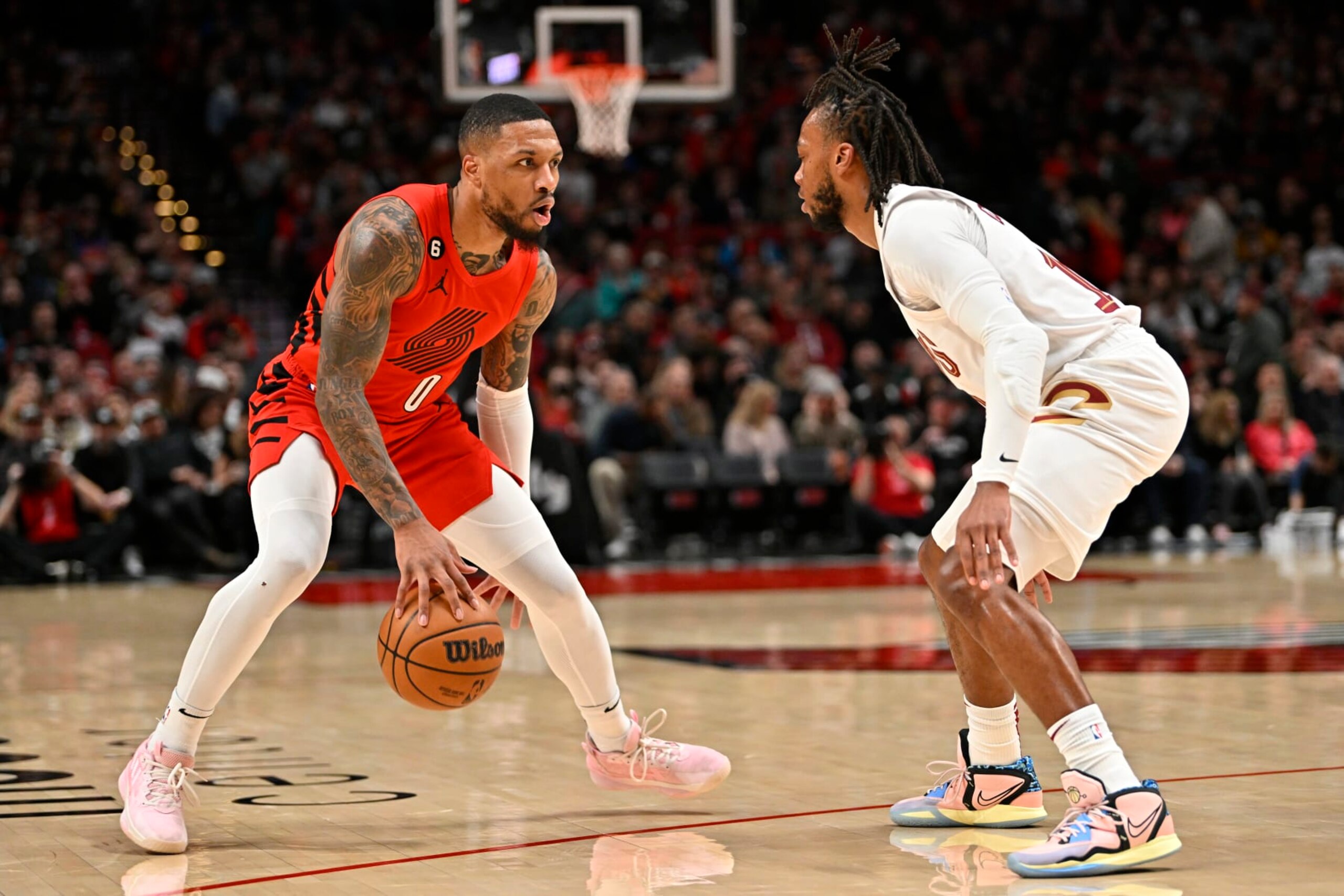PORTLAND, OREGON - JANUARY 12: Damian Lillard #0 of the Portland Trail Blazers controls the ball against Darius Garland #10 of the Cleveland Cavaliers during the first quarter at the Moda Center on January 12, 2023 in Portland, Oregon. The Cleveland Cavaliers won 119-113. NOTE TO USER: User expressly acknowledges and agrees that, by downloading and or using this photograph, User is consenting to the terms and conditions of the Getty Images License Agreement. (Photo by Alika Jenner/Getty Images)