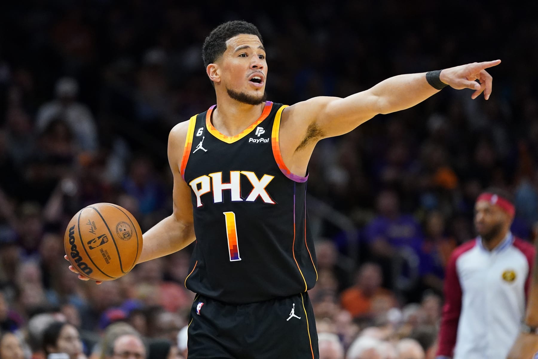 Phoenix Suns guard Devin Booker (1) calls a play during the first half of Game 3 of an NBA basketball Western Conference semifinal game against the Denver Nuggets, Friday, May 5, 2023, in Phoenix. (AP Photo/Matt York)