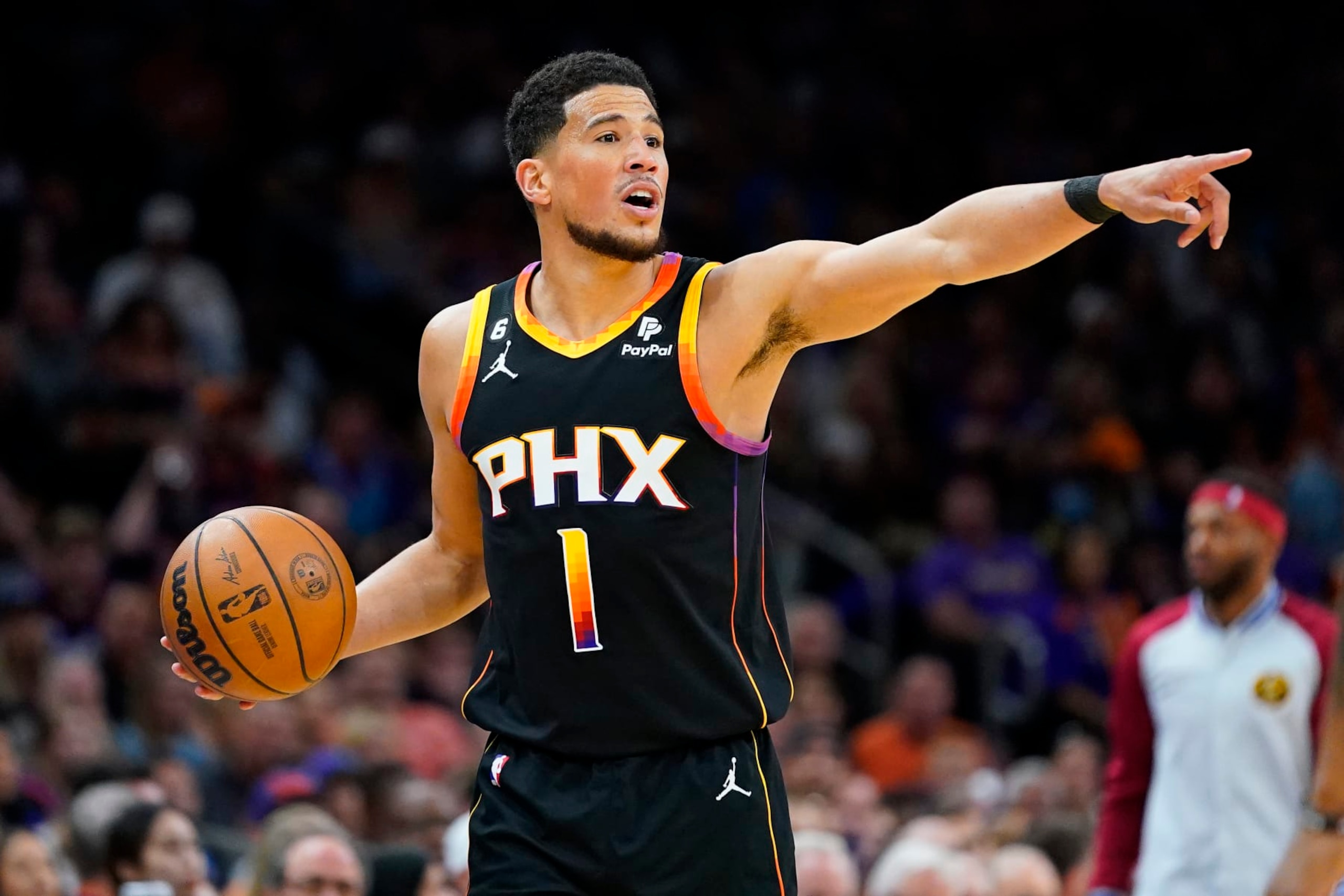 Phoenix Suns guard Devin Booker (1) calls a play during the first half of Game 3 of an NBA basketball Western Conference semifinal game against the Denver Nuggets, Friday, May 5, 2023, in Phoenix. (AP Photo/Matt York) Phoenix Suns guard Devin Booker (1) calls a play during the first half of Game 3 of an NBA basketball Western Conference semifinal game against the Denver Nuggets, Friday, May 5, 2023, in Phoenix. (AP Photo/Matt York)