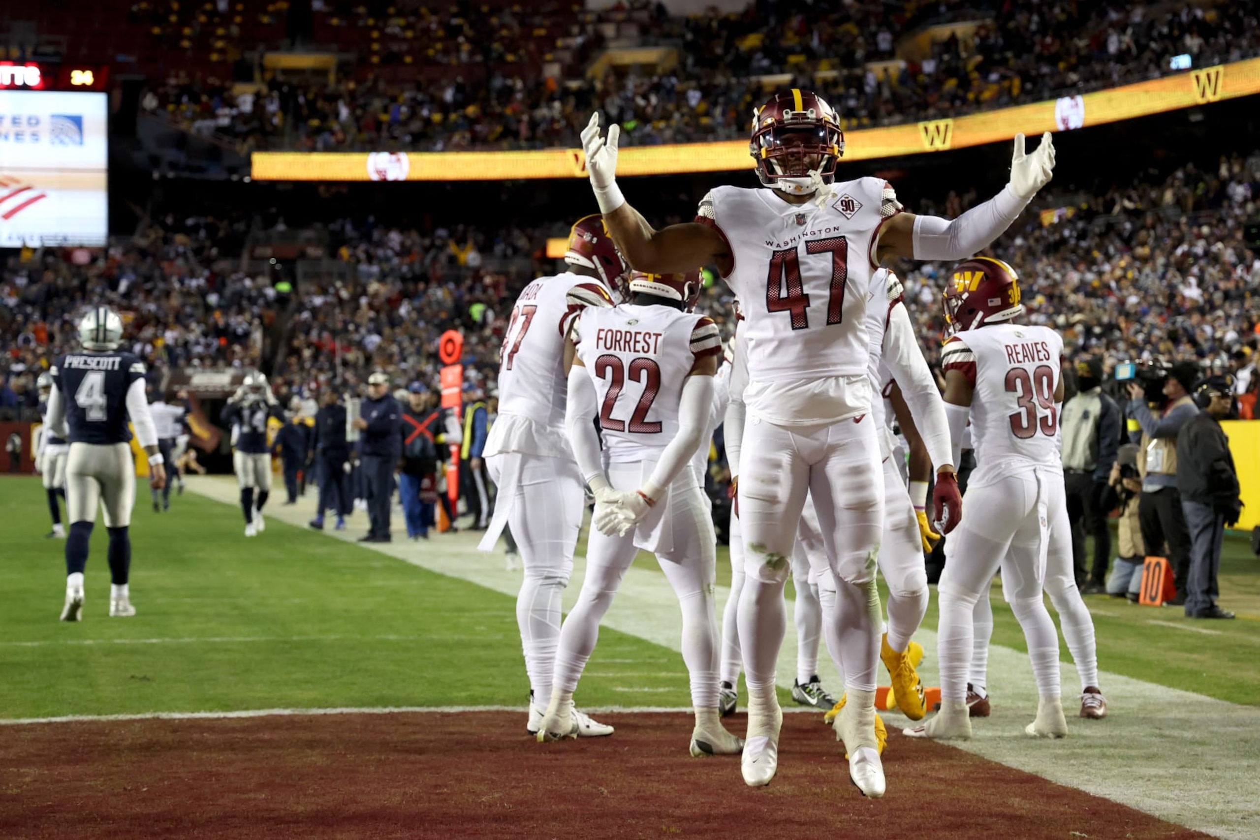 LANDOVER, MARYLAND - JANUARY 08: Linebacker Khaleke Hudson #47 of the Washington Commanders celebrates after the Commanders returned an interception for a touchdown against the Dallas Cowboys at FedExField on January 08, 2023 in Landover, Maryland. (Photo by Rob Carr/Getty Images)