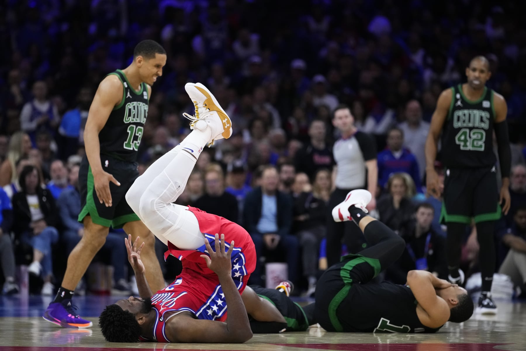 Philadelphia 76ers' Joel Embiid, front left, and Grant Williams, front right, react after colliding during the second half of Game 3 in an NBA basketball Eastern Conference semifinals playoff series, Friday, May 5, 2023, in Philadelphia. (AP Photo/Matt Slocum)