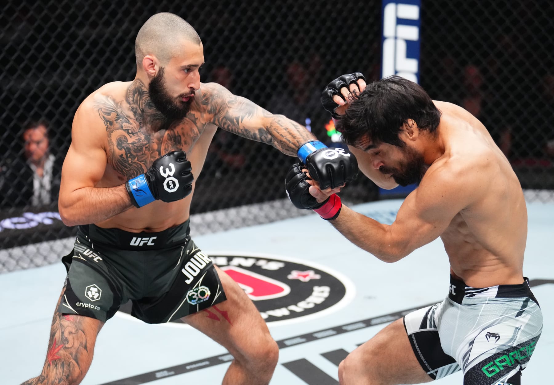 NEWARK, NEW JERSEY - MAY 06: (L-R) Charles Jourdain of Canada punches Kron Gracie of Brazil in a featherweight fight during the UFC 288 event at Prudential Center on May 06, 2023 in Newark, New Jersey. (Photo by Chris Unger/Zuffa LLC via Getty Images)
