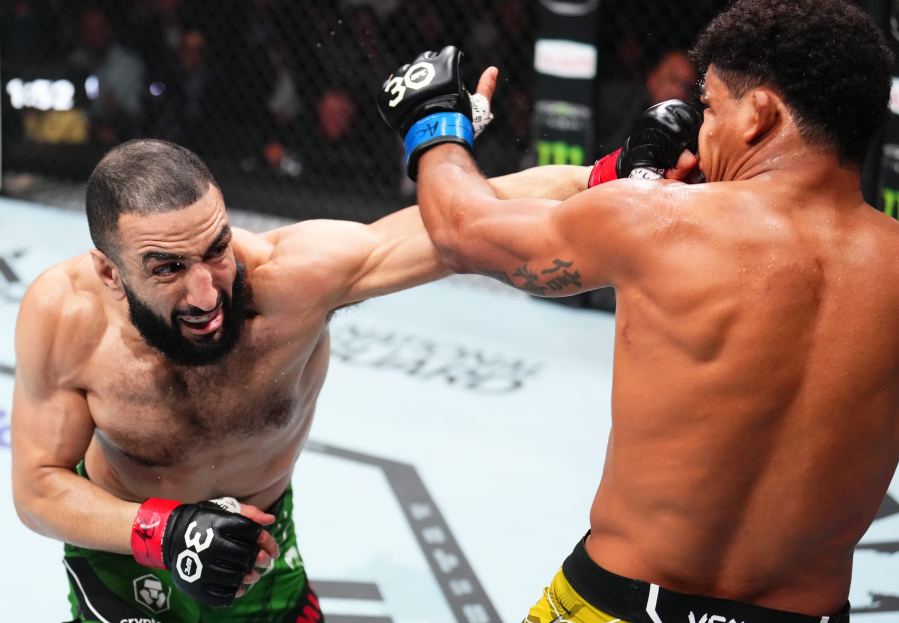 NEWARK, NEW JERSEY - MAY 06: (L-R) Belal Muhammad punches Gilbert Burns of Brazil in a welterweight fight during the UFC 288 event at Prudential Center on May 06, 2023 in Newark, New Jersey. (Photo by Chris Unger/Zuffa LLC via Getty Images)