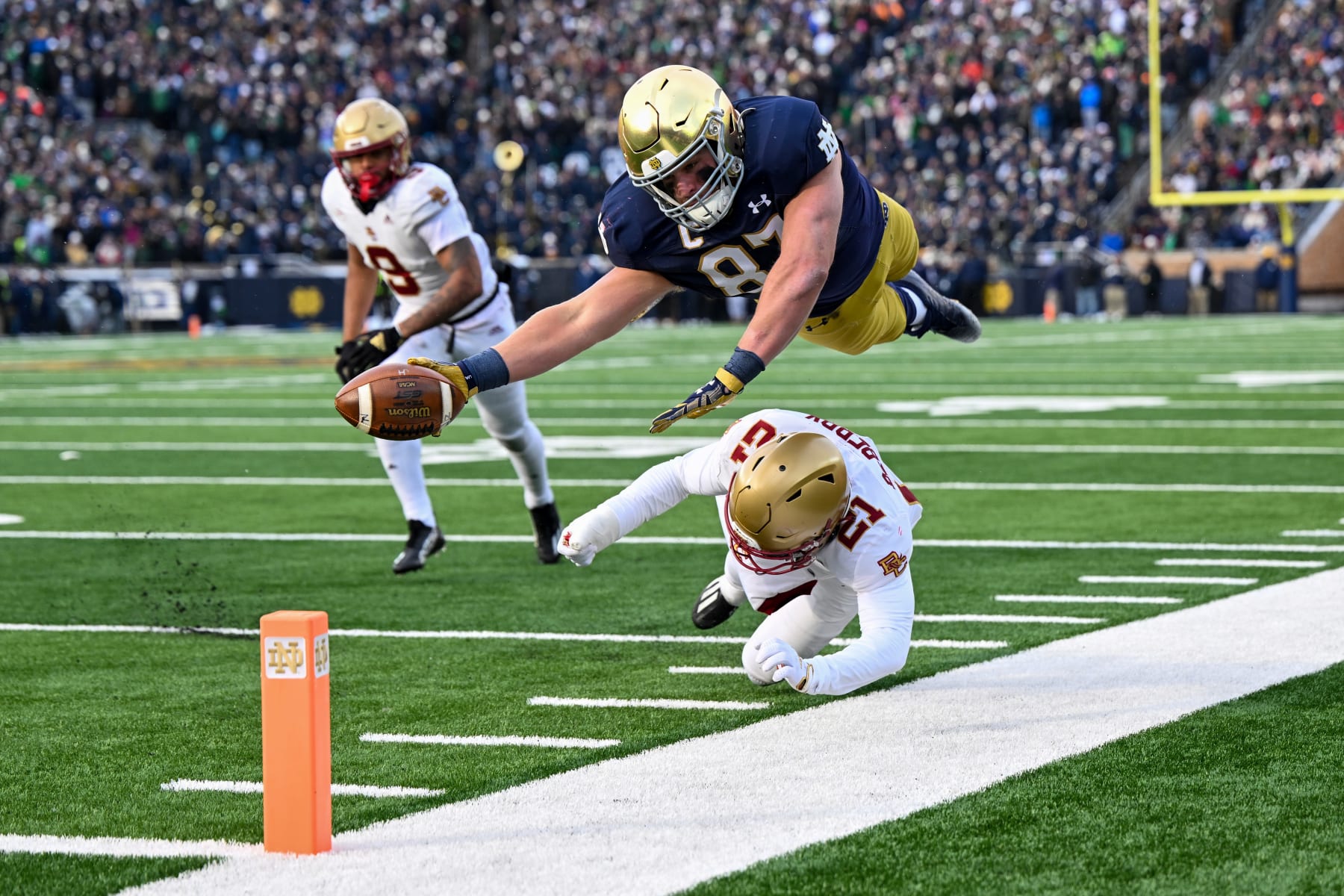 SOUTH BEND, INDIANA - NOVEMBER 19: Michael Mayer #87 of the Notre Dame Fighting Irish dives just short of the touchdown in the first half against Josh DeBerry #21 of the Boston College Eagles at Notre Dame Stadium on November 19, 2022 in South Bend, Indiana. (Photo by Quinn Harris/Getty Images)