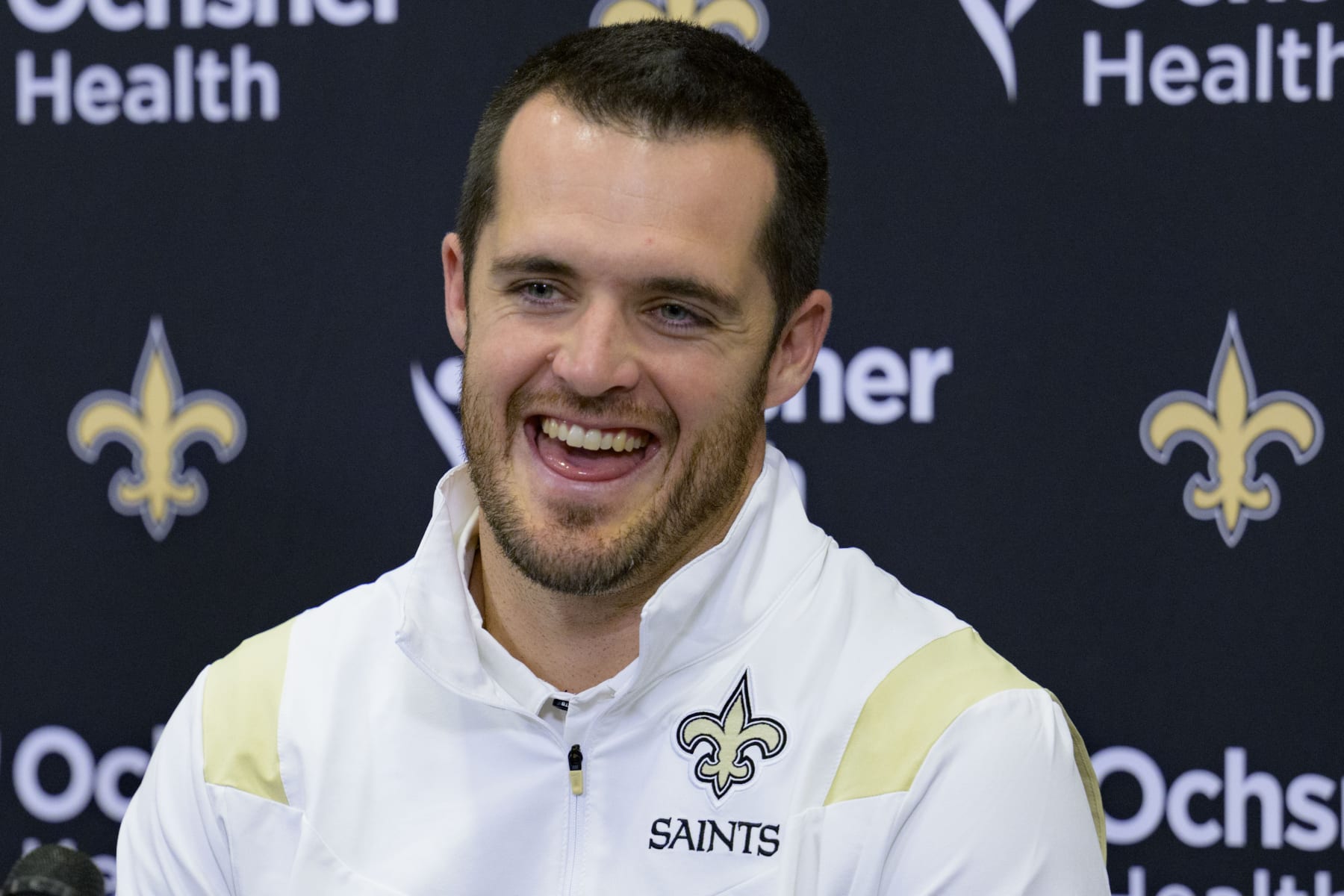 Derek Carr smiles as he is introduced as the new quarterback of the New Orleans Saints during an NFL football press conference at the team's training facility in Metairie, La., Saturday, March 11, 2023. (AP Photo/Matthew Hinton)