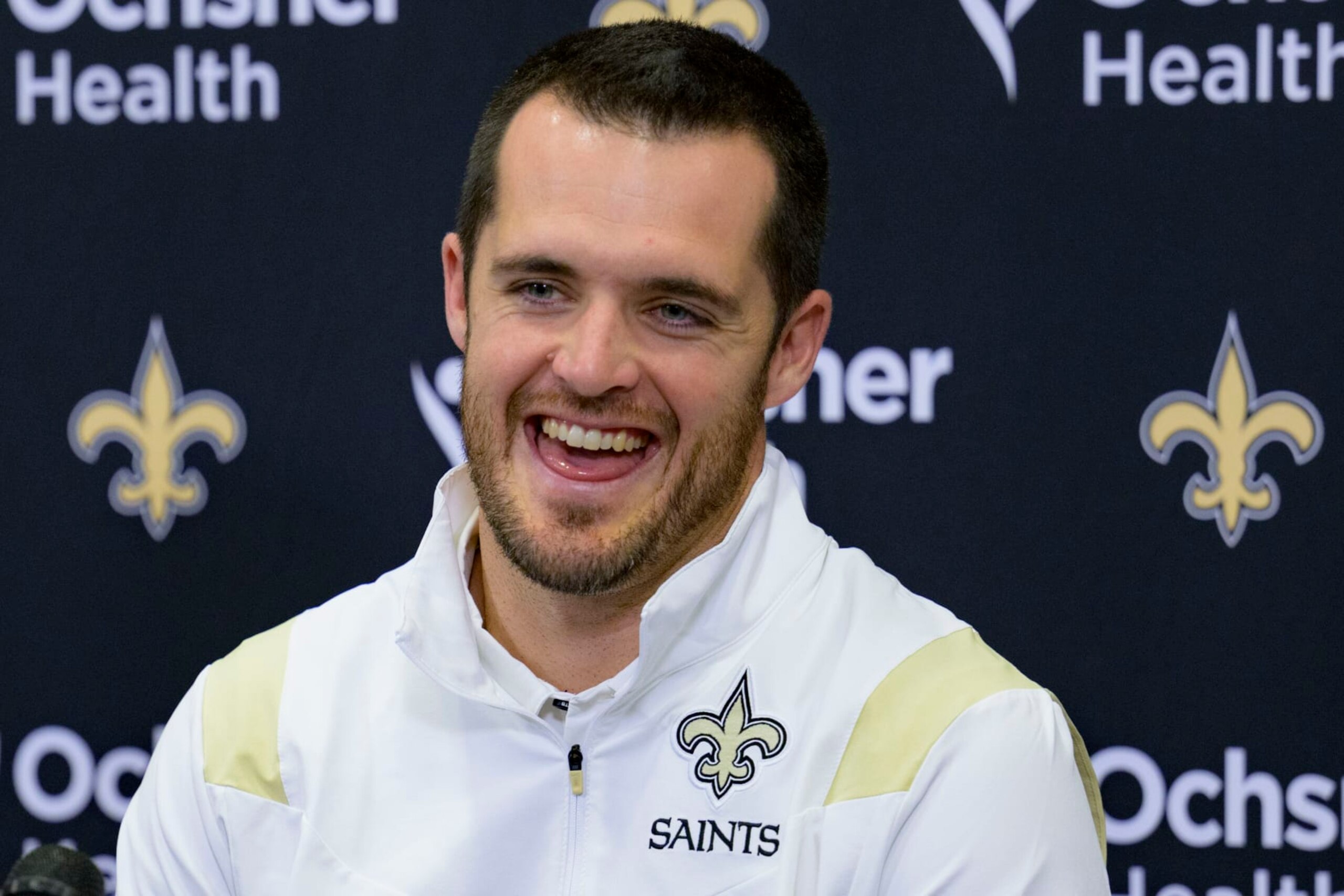 Derek Carr smiles as he is introduced as the new quarterback of the New Orleans Saints during an NFL football press conference at the team's training facility in Metairie, La., Saturday, March 11, 2023. (AP Photo/Matthew Hinton)