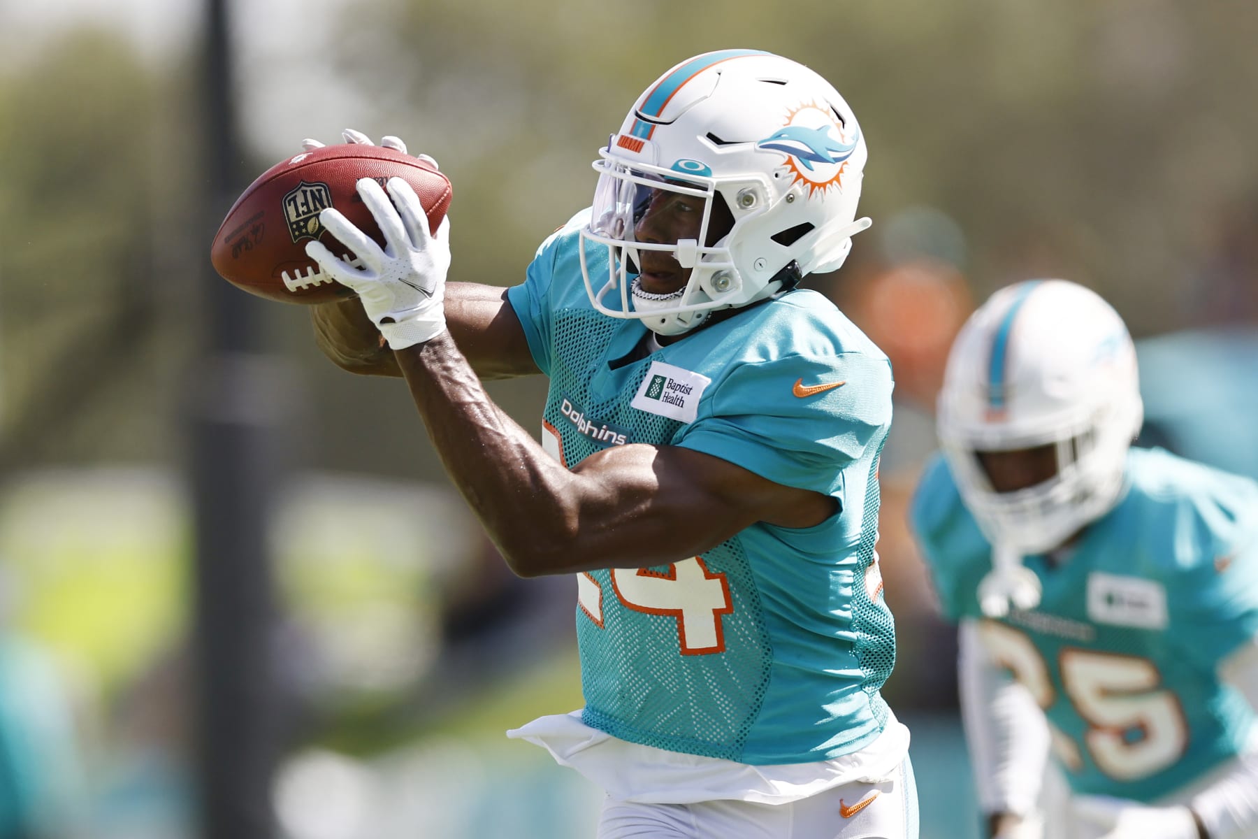 MIAMI GARDENS, FLORIDA - AUGUST 19: Byron Jones #24 of the Miami Dolphins catches the ball during joint practice with the Atlanta Falcons at Baptist Health Training Complex on August 19, 2021 in Miami Gardens, Florida. (Photo by Michael Reaves/Getty Images)