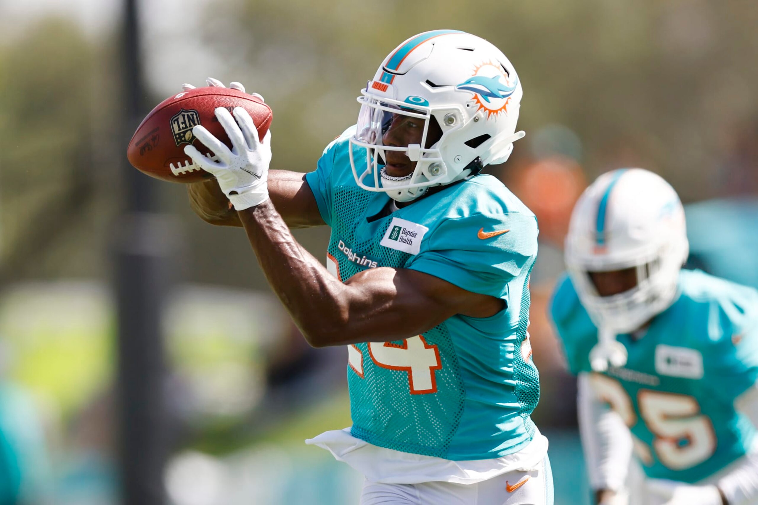 MIAMI GARDENS, FLORIDA - AUGUST 19: Byron Jones #24 of the Miami Dolphins catches the ball during joint practice with the Atlanta Falcons at Baptist Health Training Complex on August 19, 2021 in Miami Gardens, Florida. (Photo by Michael Reaves/Getty Images)