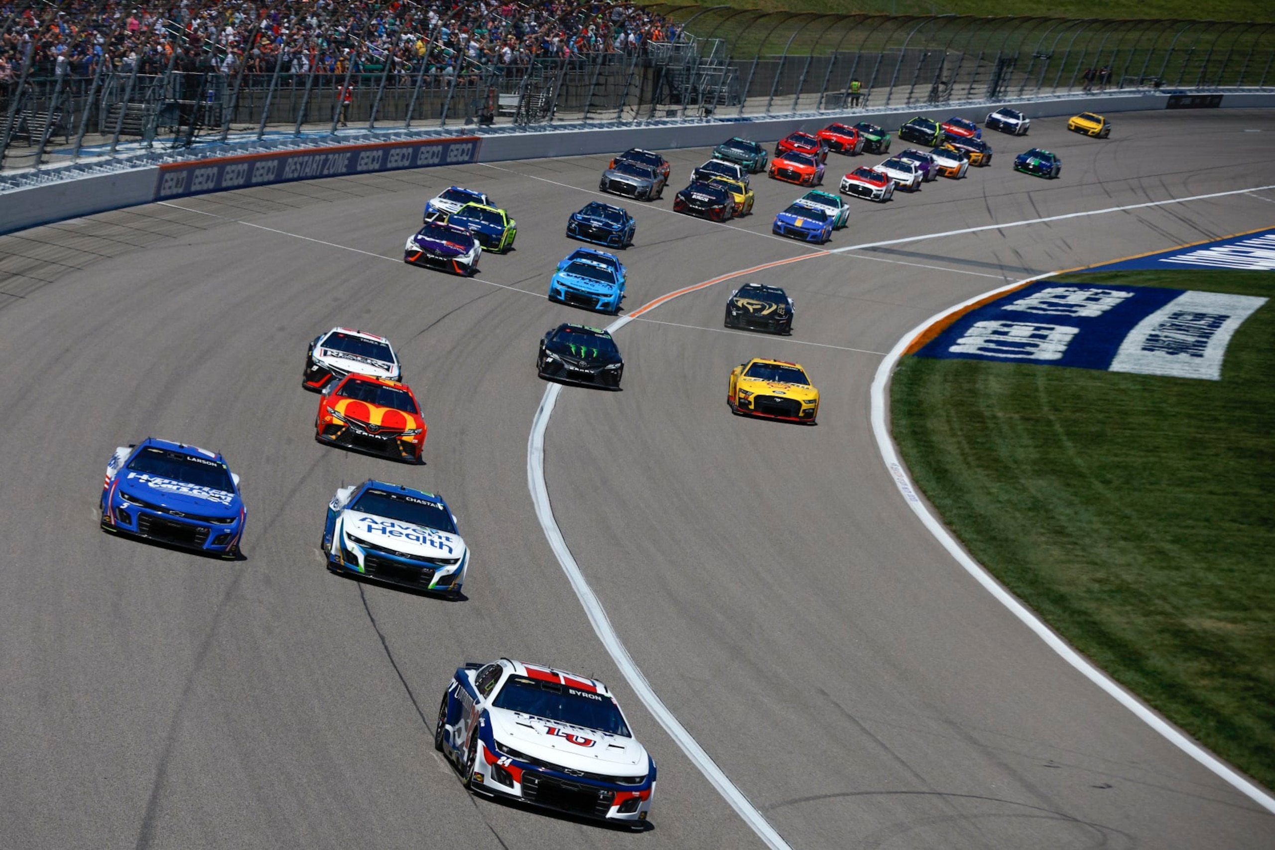 KANSAS CITY, KANSAS - MAY 07: William Byron, driver of the #24 Liberty University Chevrolet, Ross Chastain, driver of the #1 AdventHealth Chevrolet, Kyle Larson, driver of the #5 HendrickCars.com Chevrolet, Tyler Reddick, driver of the #45 McDonald's Toyota, and Martin Truex Jr., driver of the #19 Reser's Fine Foods Toyota, race during the NASCAR Cup Series Advent Health 400 at Kansas Speedway on May 07, 2023 in Kansas City, Kansas. (Photo by Sean Gardner/Getty Images)