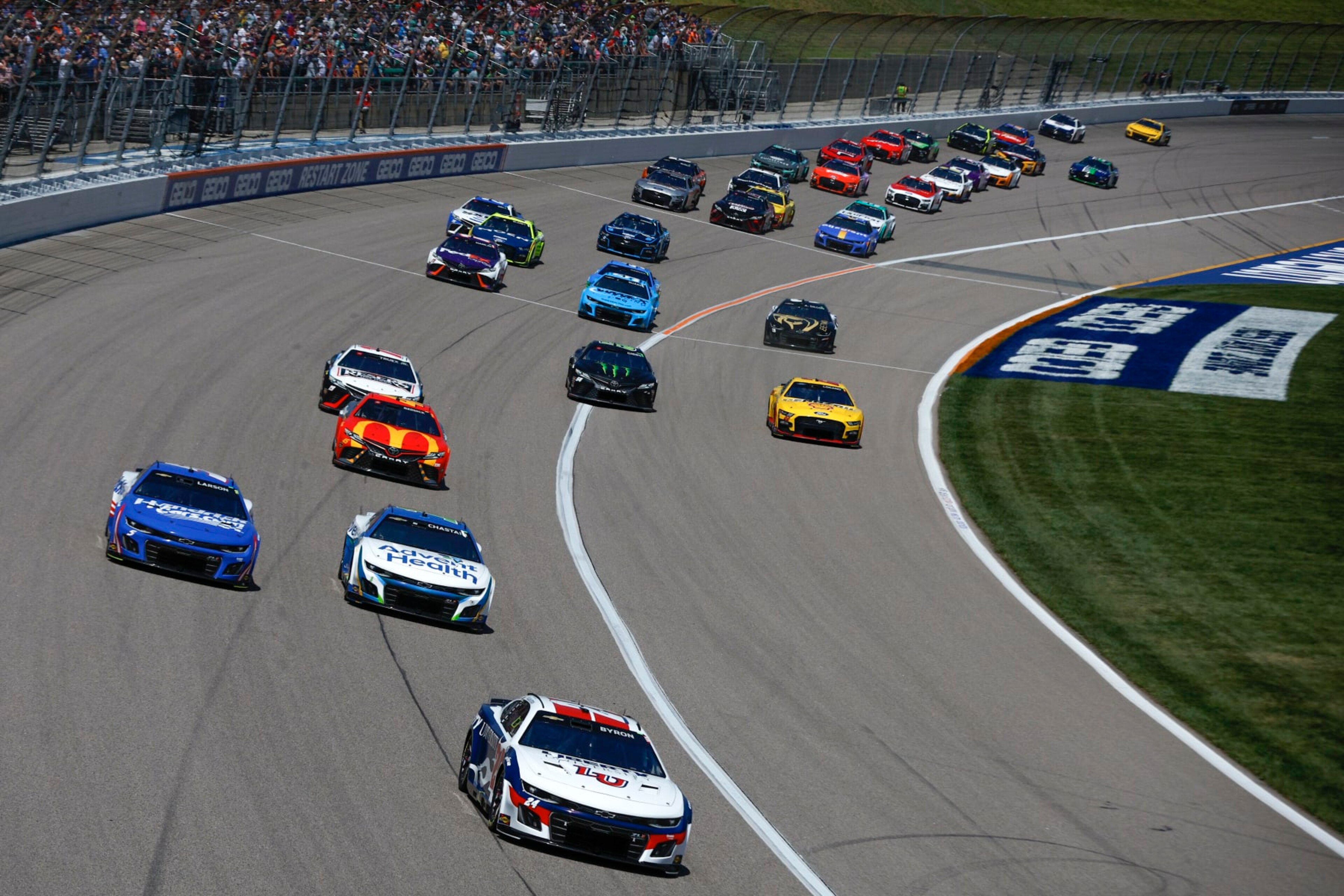 KANSAS CITY, KANSAS - MAY 07: William Byron, driver of the #24 Liberty University Chevrolet, Ross Chastain, driver of the #1 AdventHealth Chevrolet, Kyle Larson, driver of the #5 HendrickCars.com Chevrolet, Tyler Reddick, driver of the #45 McDonald's Toyota, and Martin Truex Jr., driver of the #19 Reser's Fine Foods Toyota, race during the NASCAR Cup Series Advent Health 400 at Kansas Speedway on May 07, 2023 in Kansas City, Kansas. (Photo by Sean Gardner/Getty Images)