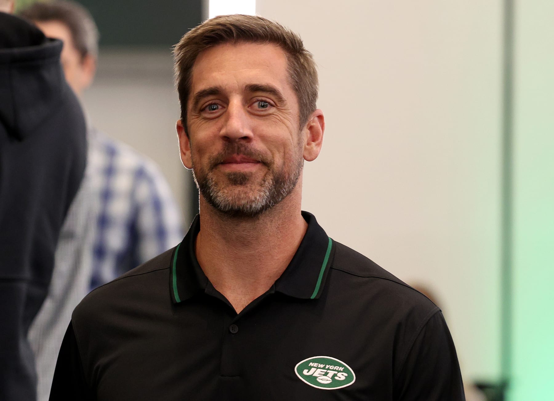 FLORHAM PARK, NEW JERSEY - APRIL 26: New York Jets quarterback Aaron Rodgers walks out after a press conference to introduce Aaron Rodgers as the new quarterback for the New York Jets at Atlantic Health Jets Training Center on April 26, 2023 in Florham Park, New Jersey. (Photo by Elsa/Getty Images)