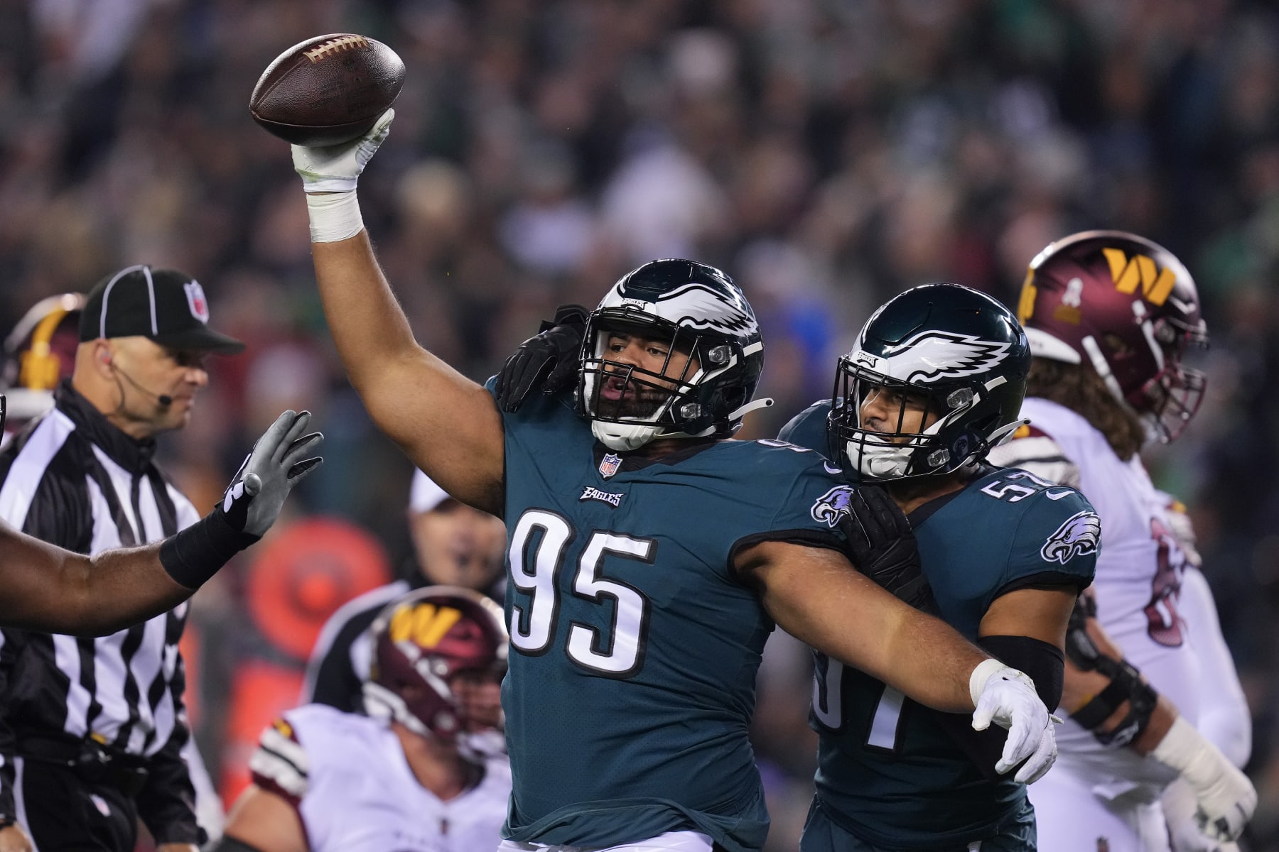 PHILADELPHIA, PA - NOVEMBER 14: Marlon Tuipulotu #95 and T.J. Edwards #57 of the Philadelphia Eagles react after a fumble recovery against the Washington Commanders at Lincoln Financial Field on November 14, 2022 in Philadelphia, Pennsylvania. (Photo by Mitchell Leff/Getty Images)