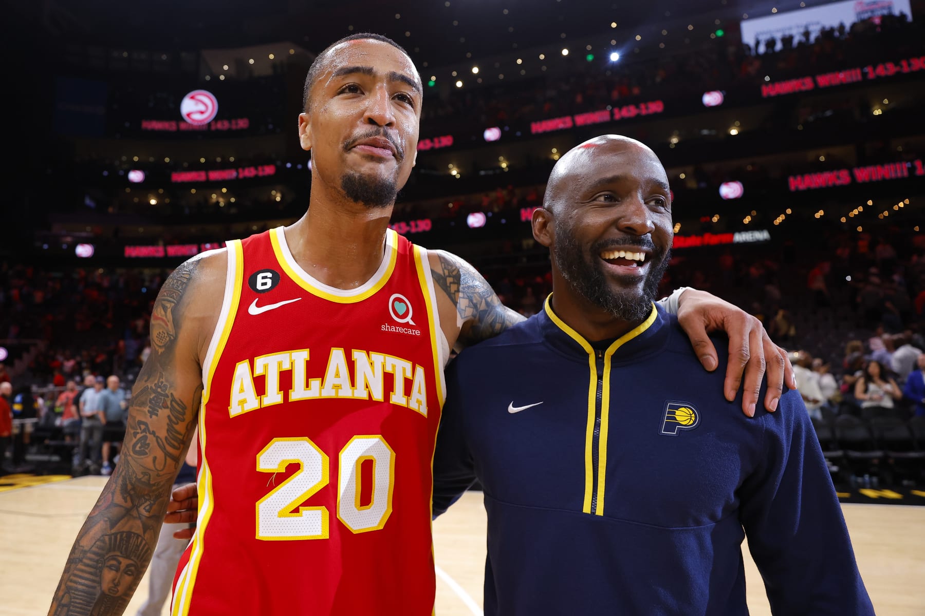 ATLANTA, GA - MARCH 25: John Collins #20 of the Atlanta Hawks speaks with Lead Assistant Coach Lloyd Pierce of the Indiana Pacers following the 143-130 victory over the Indiana Pacers at State Farm Arena on March 25, 2023 in Atlanta, Georgia. NOTE TO USER: User expressly acknowledges and agrees that, by downloading and or using this photograph, User is consenting to the terms and conditions of the Getty Images License Agreement. (Photo by Todd Kirkland/Getty Images)