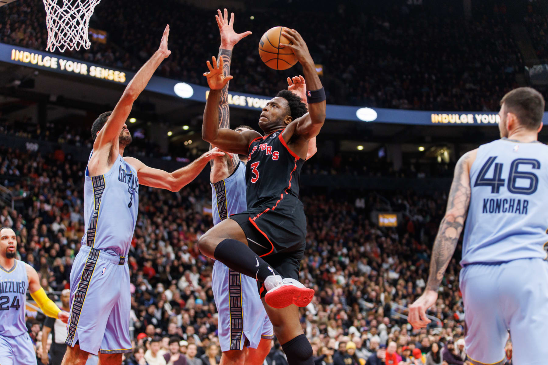 TORONTO, ON - DECEMBER 29: O.G. Anunoby #3 of the Toronto Raptors drives to the net against Santi Aldama #7 of the Memphis Grizzlies during the first half of their NBA game at Scotiabank Arena on December 29, 2022 in Toronto, Canada. NOTE TO USER: User expressly acknowledges and agrees that, by downloading and or using this photograph, User is consenting to the terms and conditions of the Getty Images License Agreement. (Photo by Cole Burston/Getty Images)
